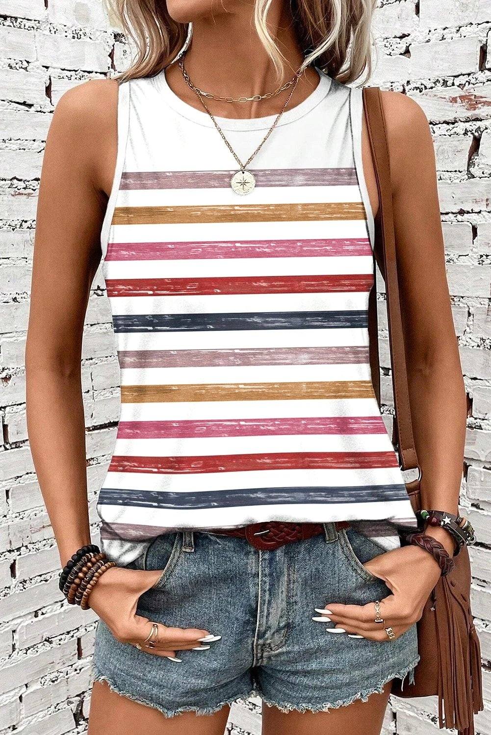 Woman wearing a rainbow striped round-neck tank top with a relaxed fit and sleeveless design