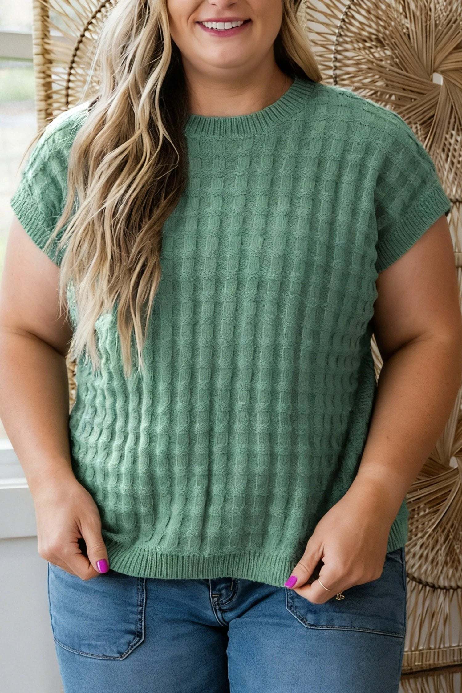 Plus size woman wearing mist green textured knit short sleeve sweater with ribbed hem