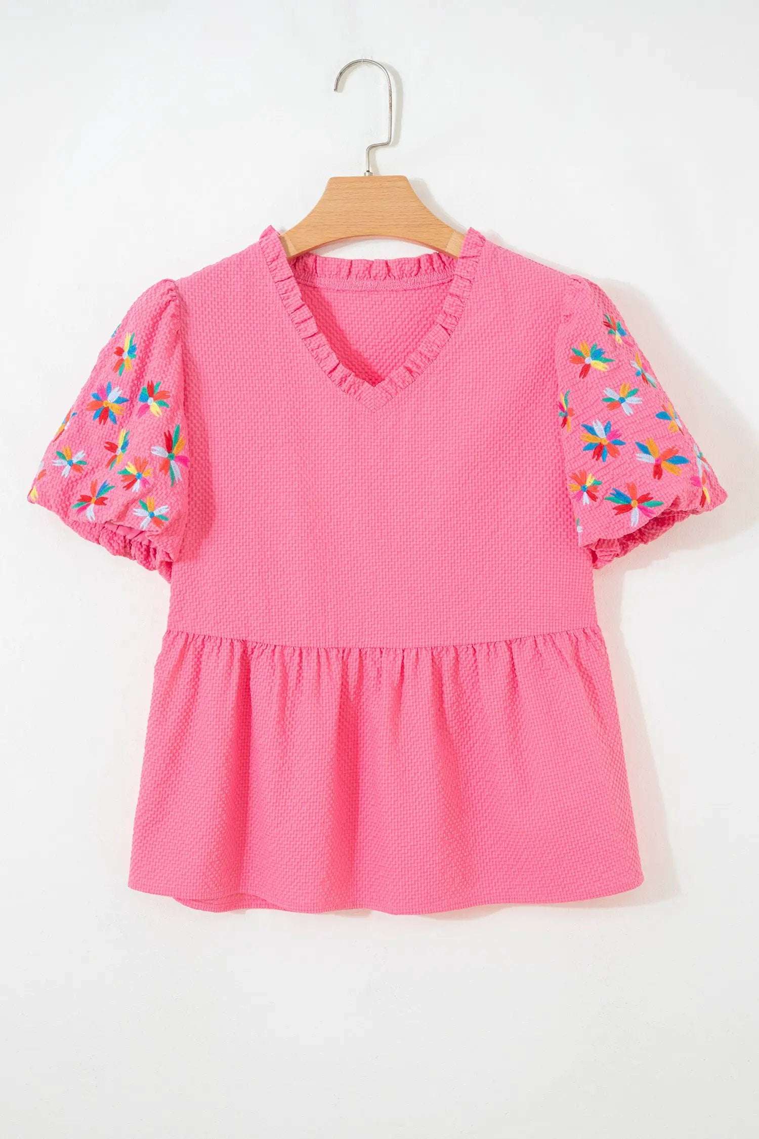 V-neck floral embroidered blouse with puff sleeves and textured fabric