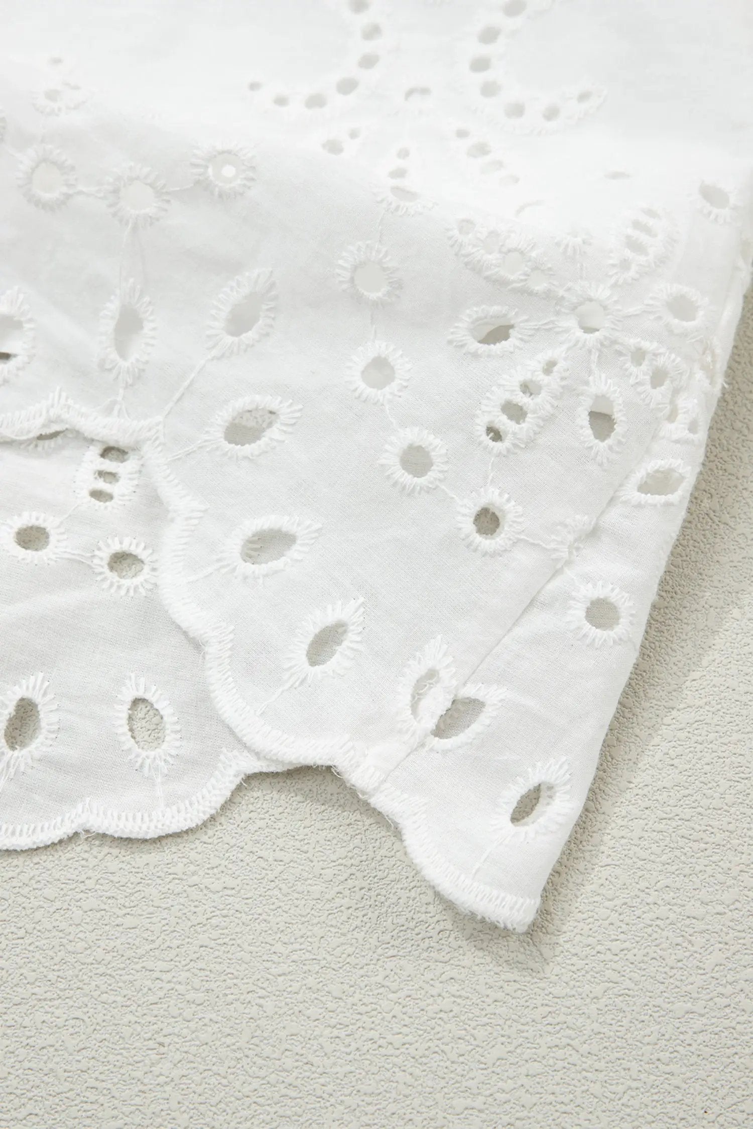 White solid color eyelet embroidered T-shirt mini dress with airy texture and relaxed A-line silhouette