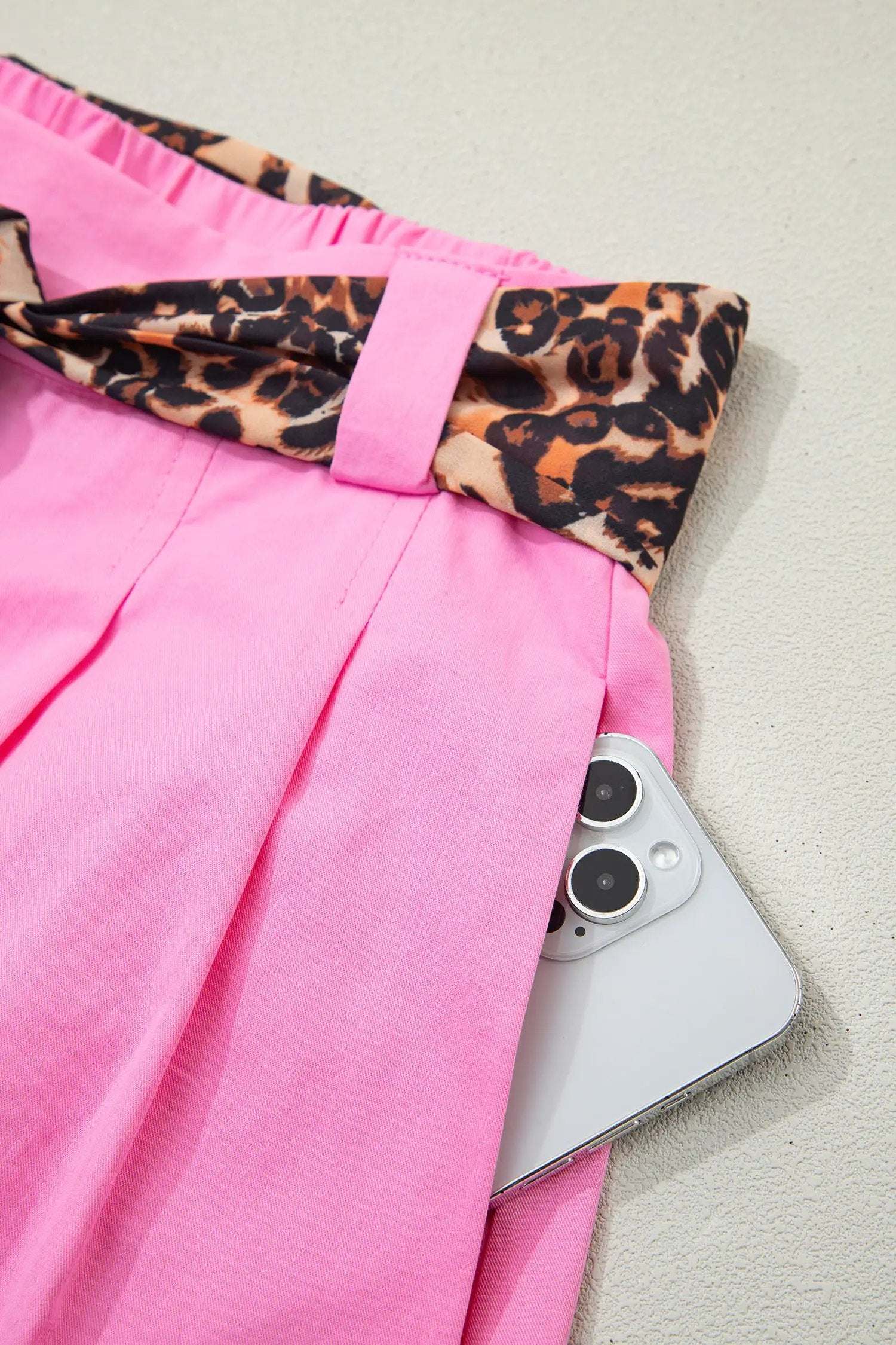 Pink pleated wide-leg shorts with leopard contrast sash belt for Weekend Vibe style
