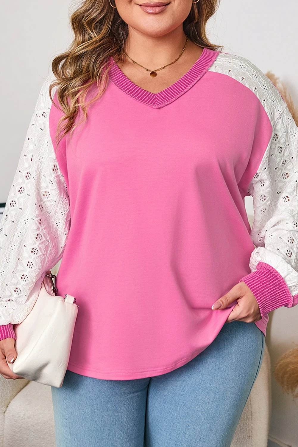 Plus size V-neck top with lace stripe sleeves and corded trim on plus size model