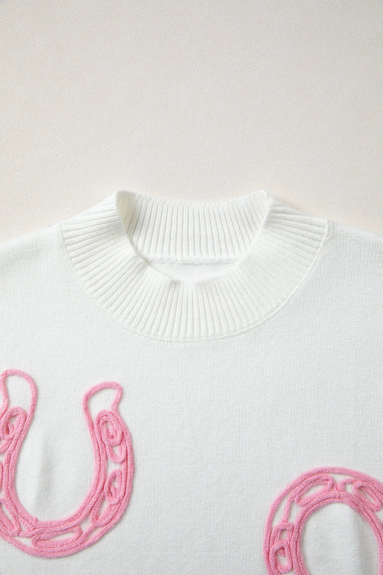 Bright green ribbed mock neck short sleeve knit sweater with pink horseshoe embroidery