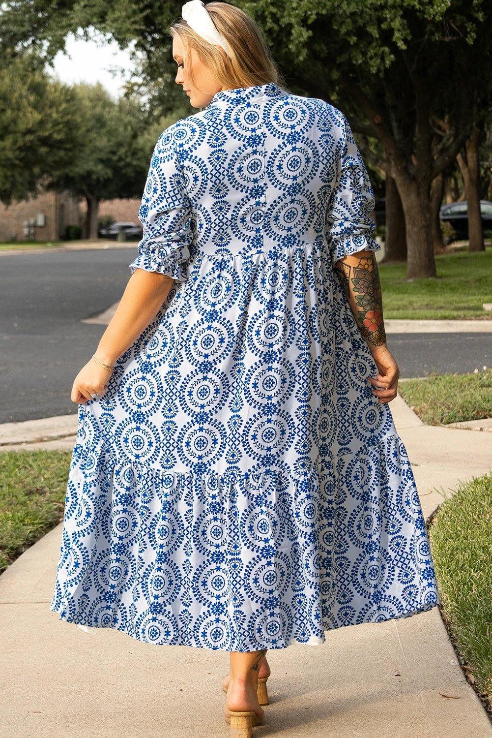 Plus size blue and white geometric print maxi dress with lace-up notch neck on a model