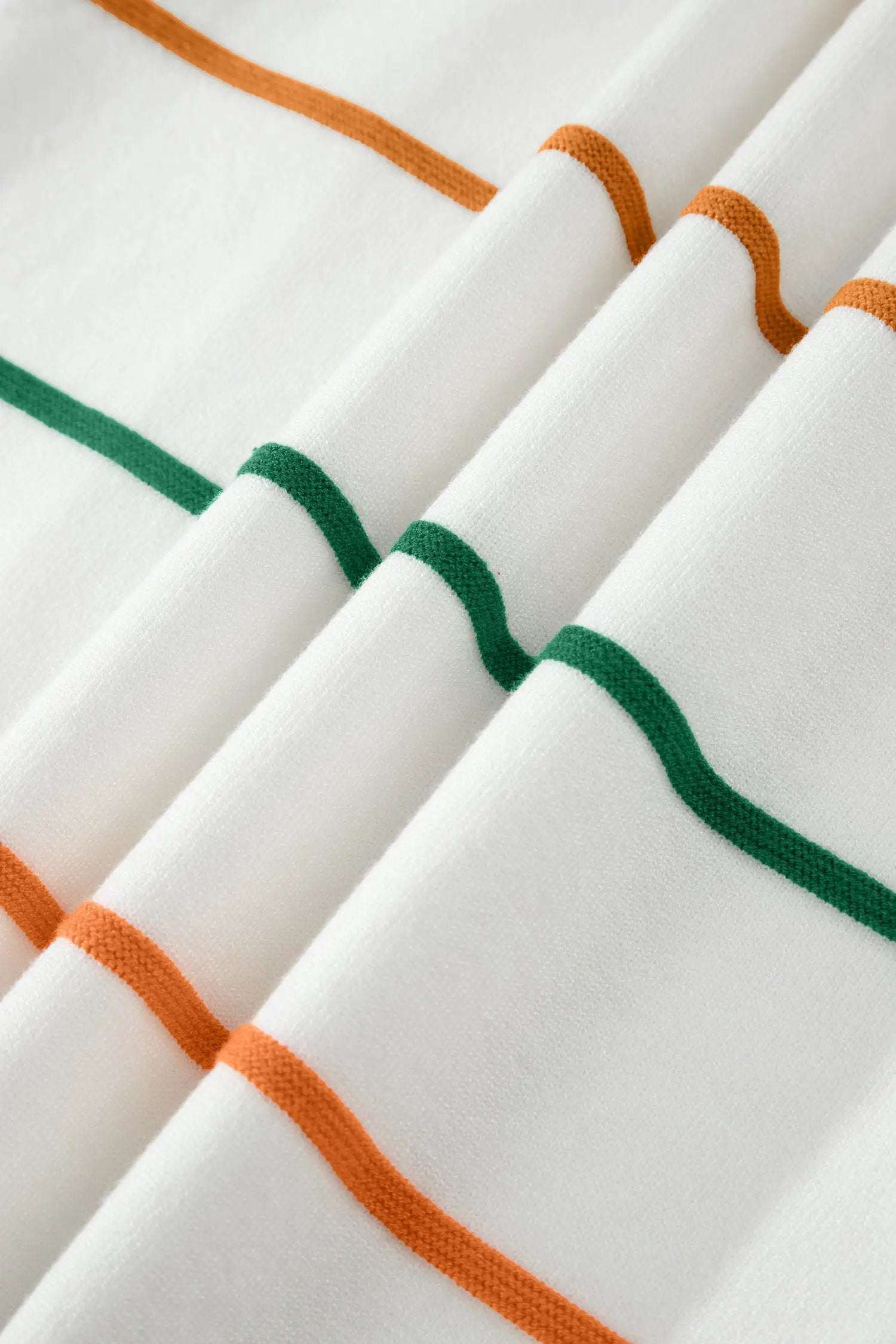 Woman wearing a stripe round-neck knit sleeveless tank with color-block accents
