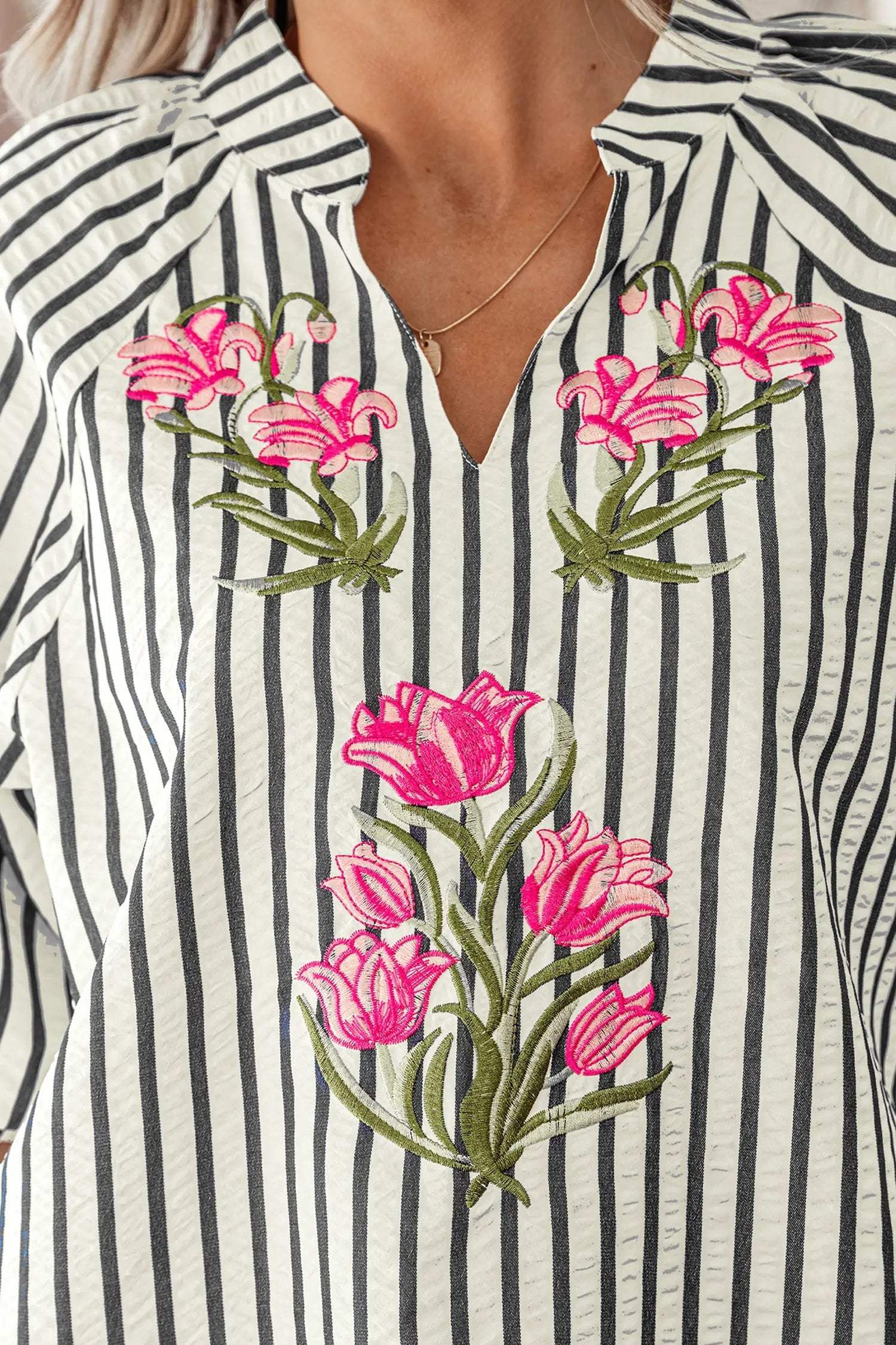 Navy and cream striped V-neck blouse with floral embroidery, short sleeves, and relaxed fit, embodying cool mom energy