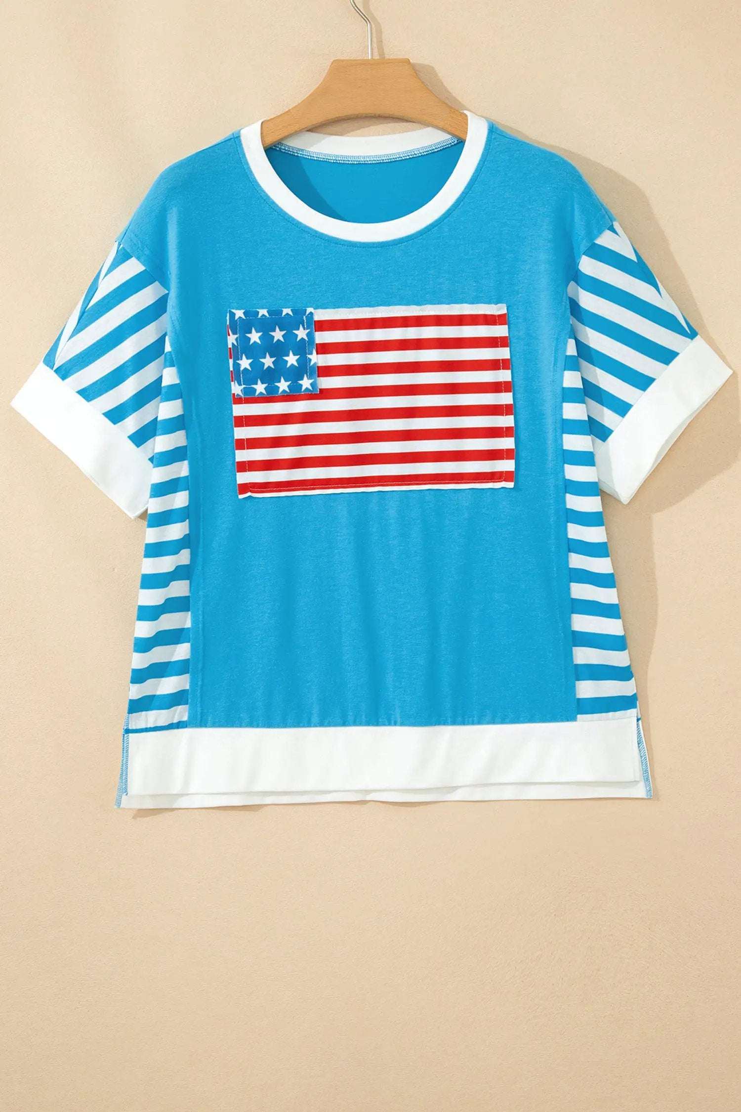 Woman wearing a patchwork US flag t-shirt with colorblock sleeves and star accents