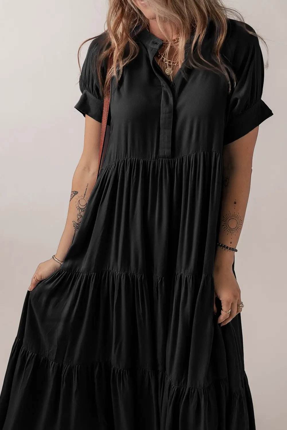 Black tiered ruffle maxi dress with hidden buttons and short sleeves for effortless chic style