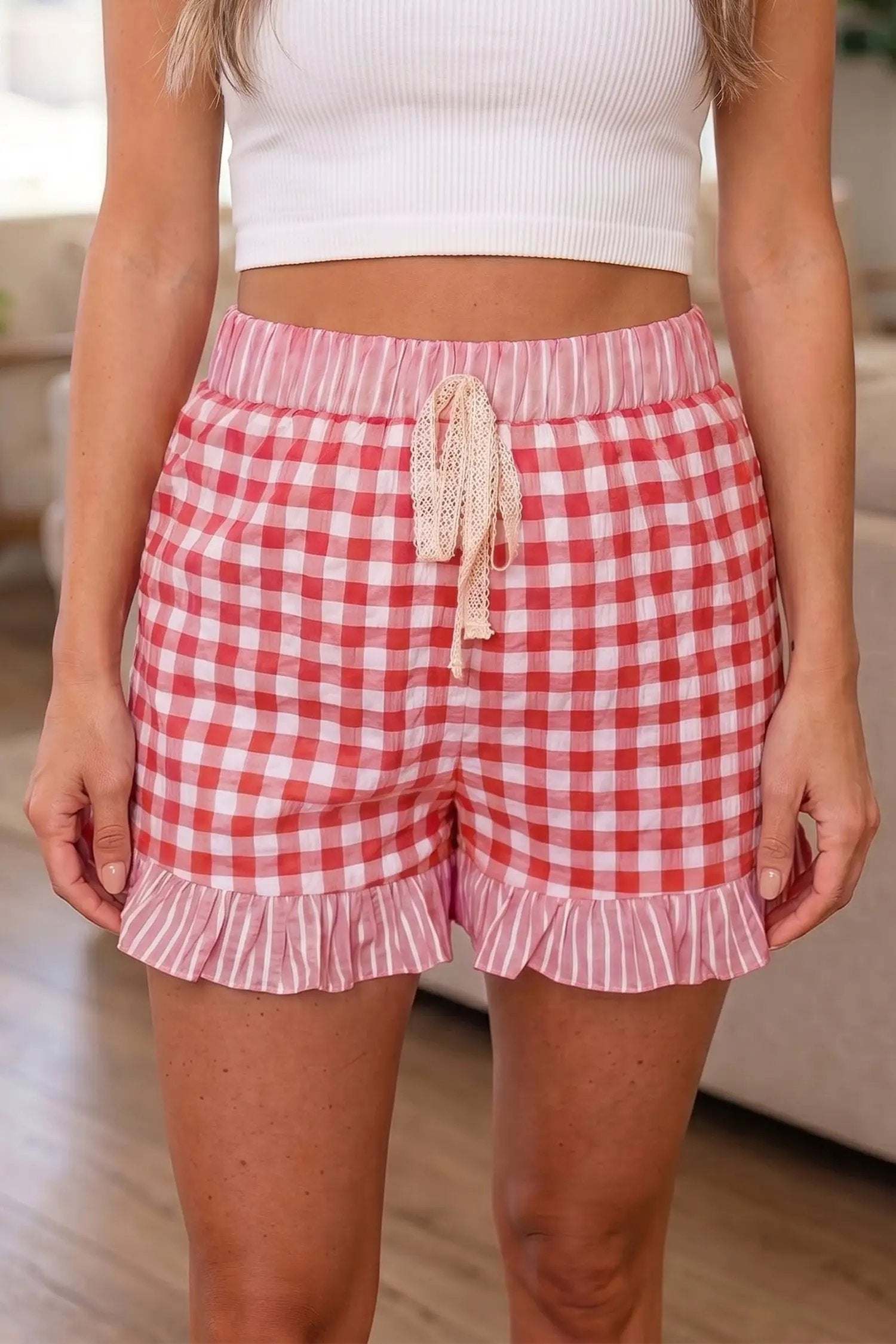 Woman wearing gingham ruffle hem shorts with lace tie waist in casual weekend setting