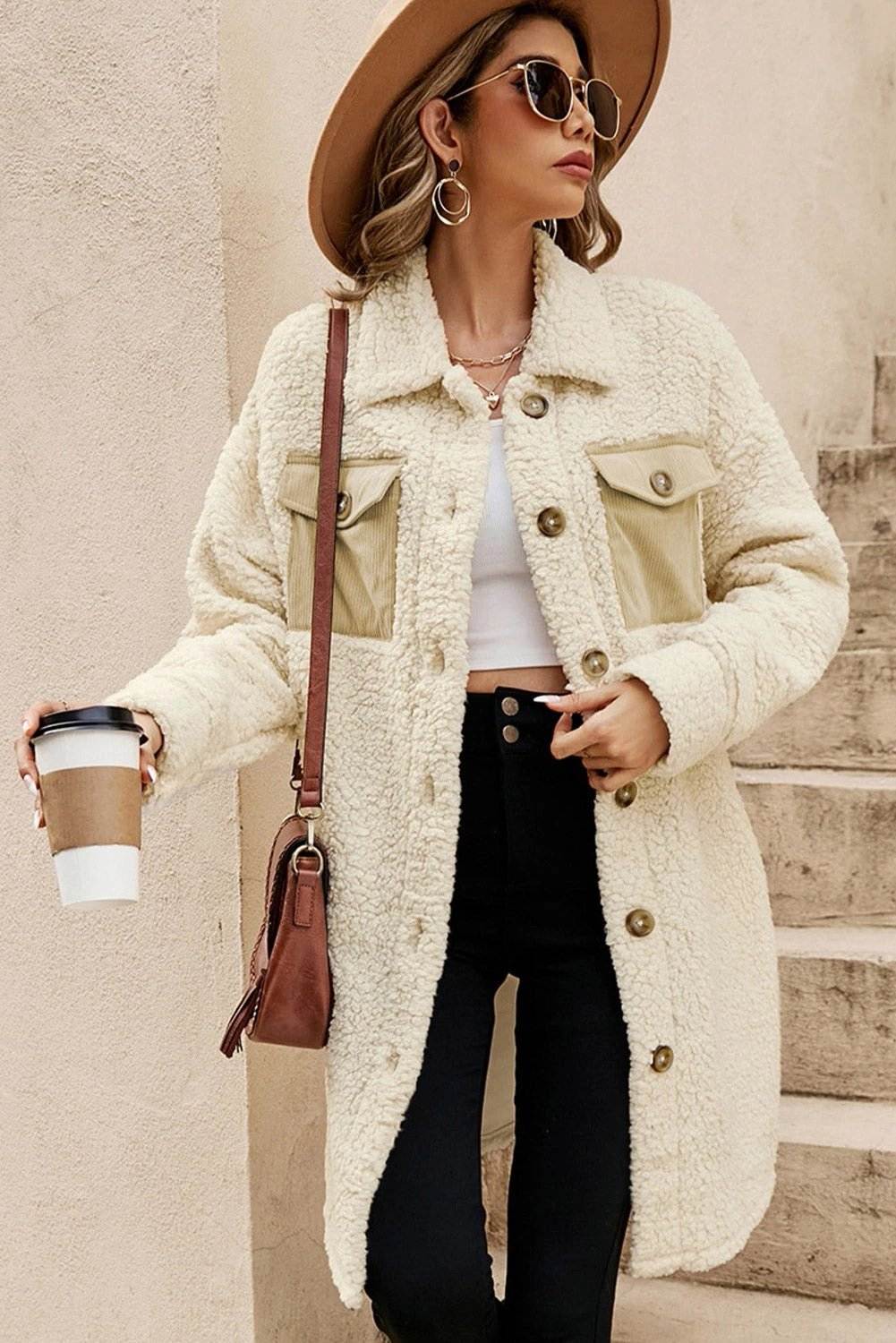 Woman wearing cozy teddy fleece coat with navy contrast flap pockets and single-breasted front