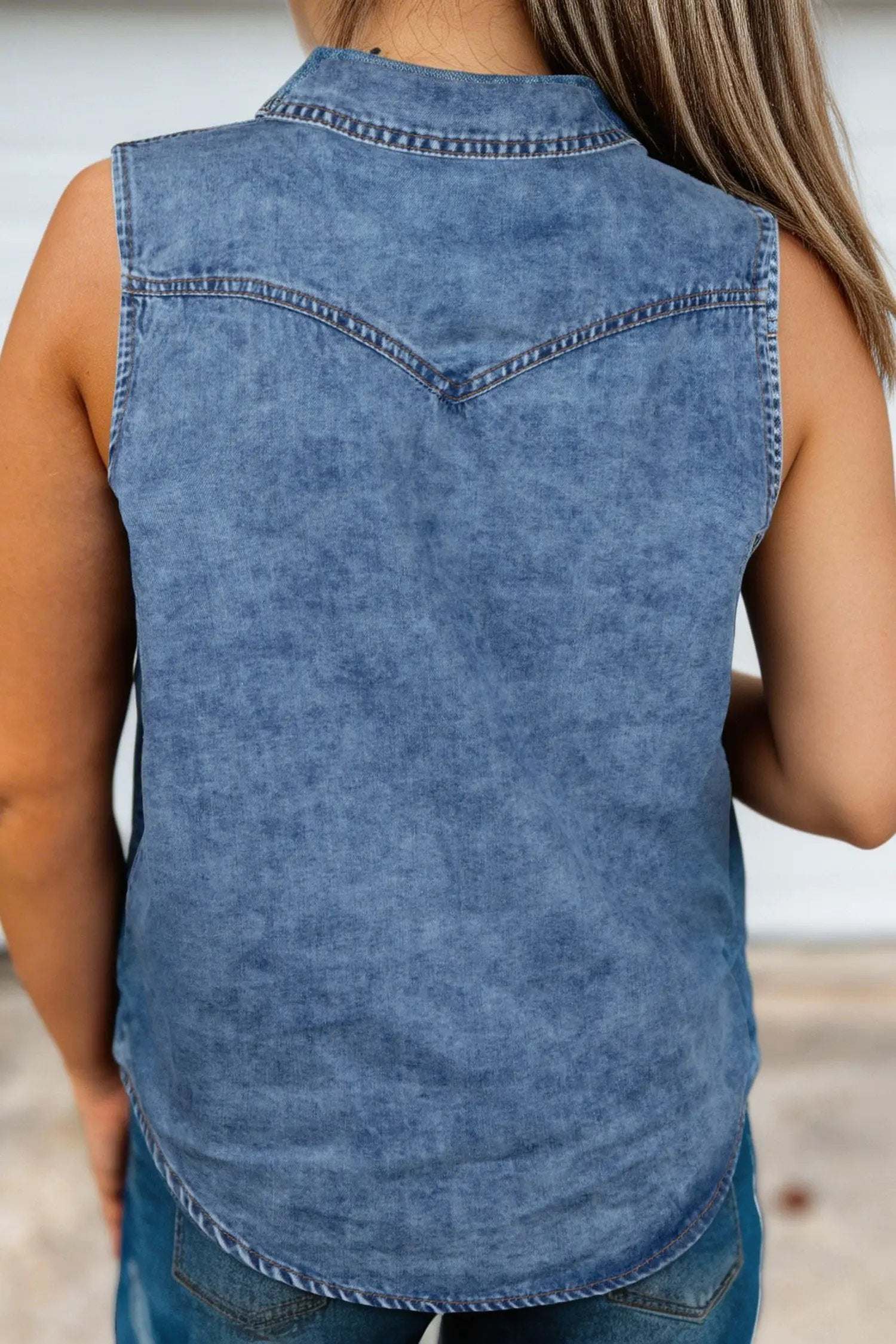 Sleeveless Western Chic button-front collared denim top in soft blue with metallic snaps and chest pockets