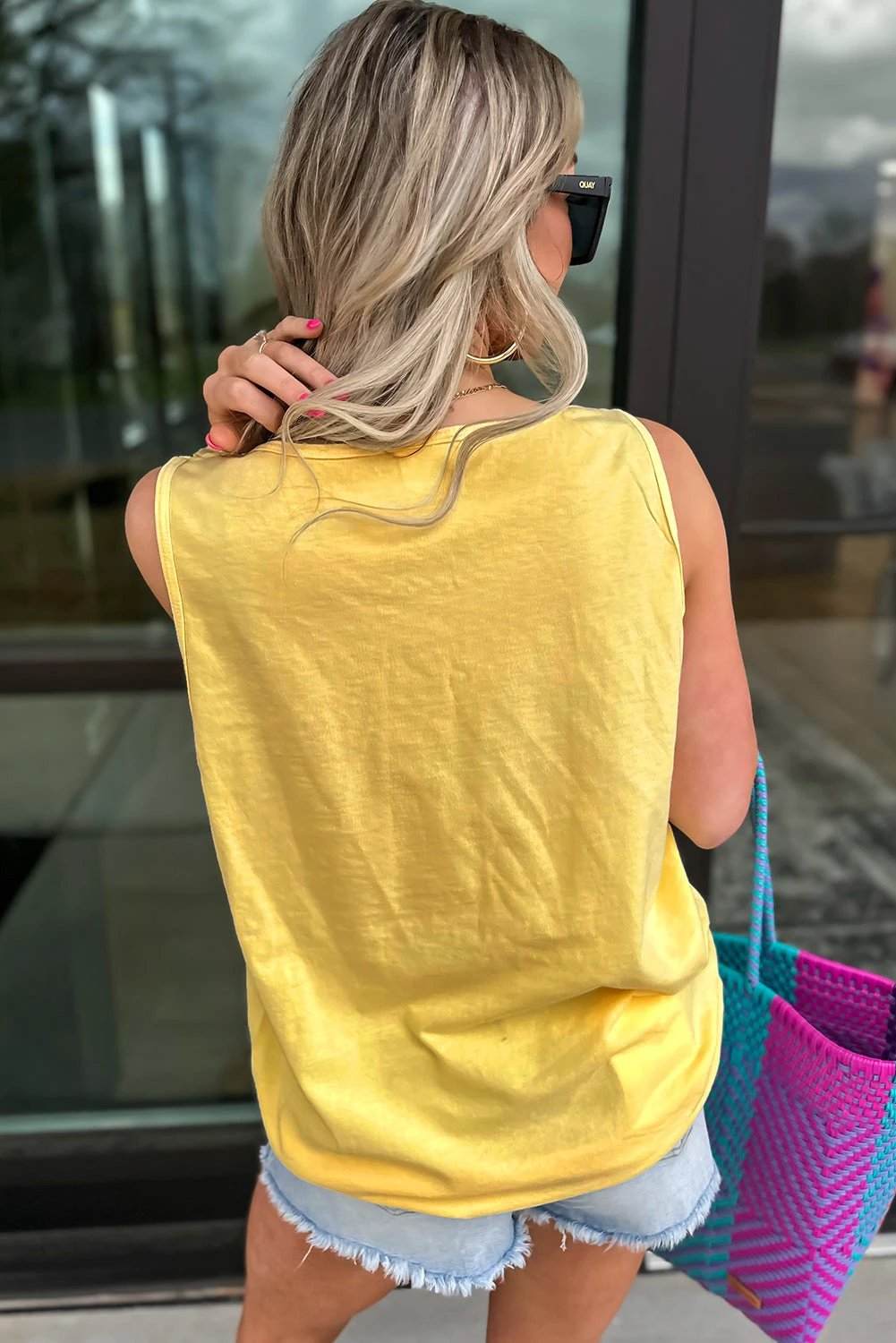 Sun-kissed yellow floral graphic tank top with soft breathable fabric and relaxed fit