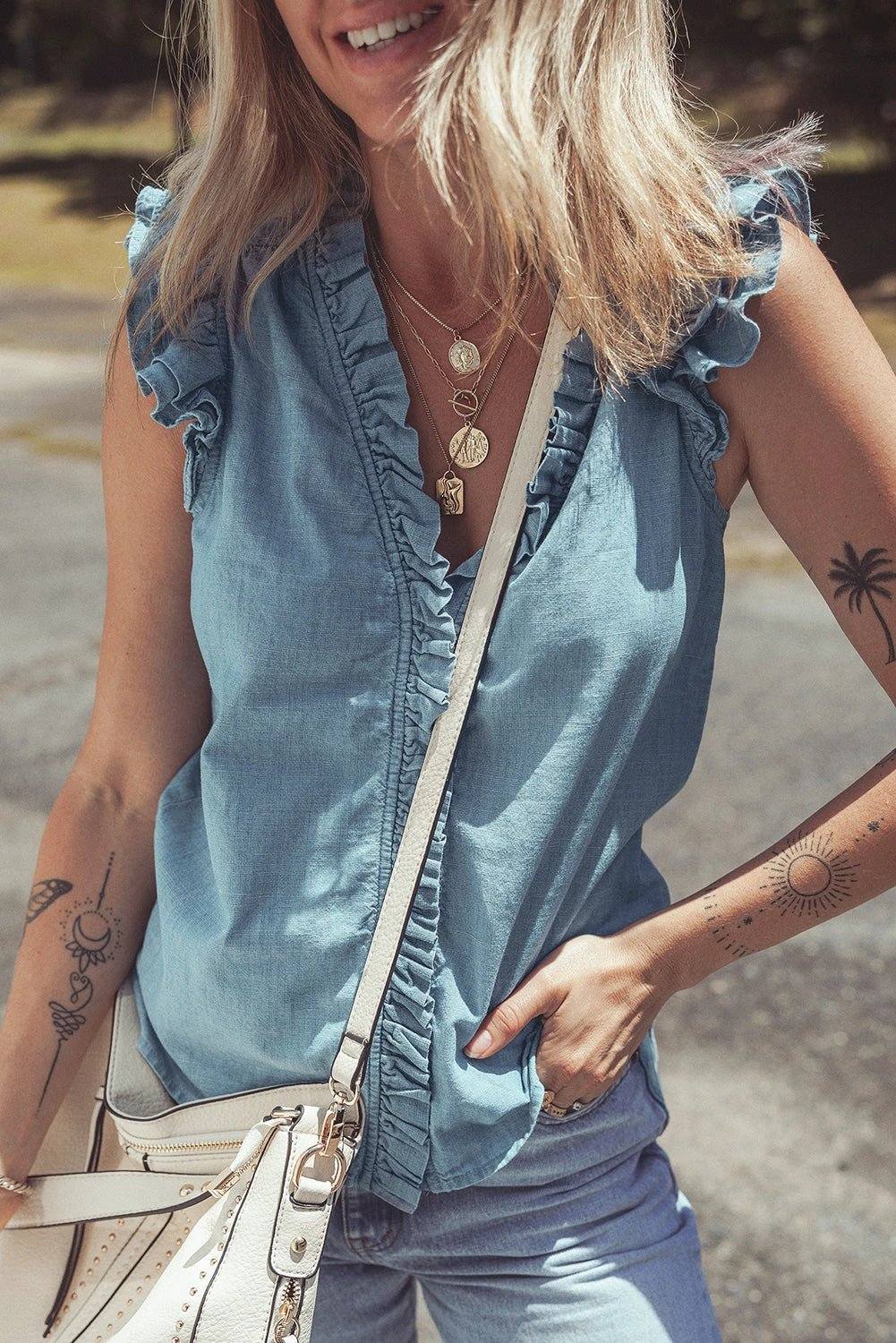 Woman wearing frill trim V-neck chambray tank top embodying chic mom energy