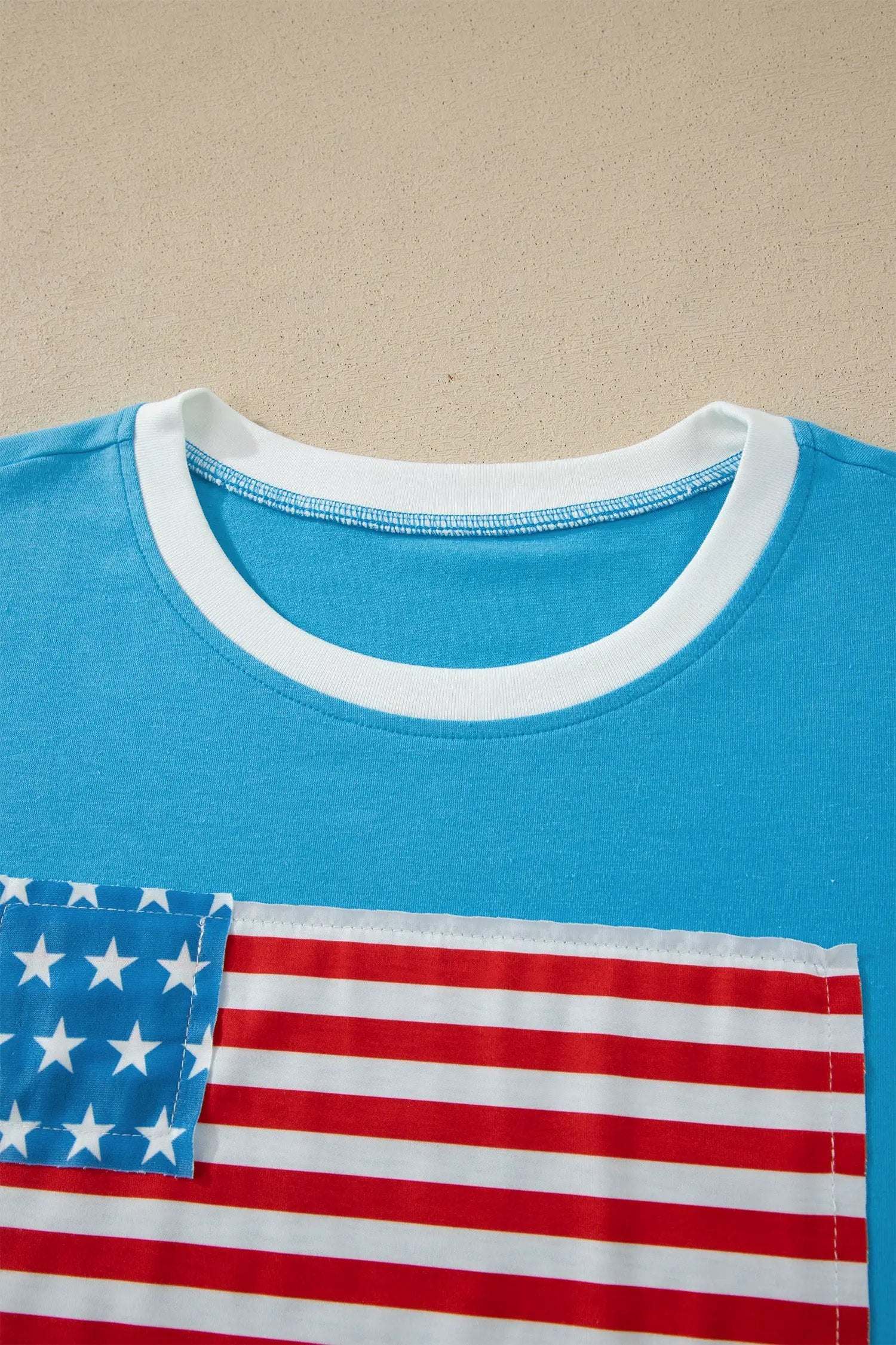 Woman wearing patchwork US flag t-shirt with colorblock sleeves and starry chest panel