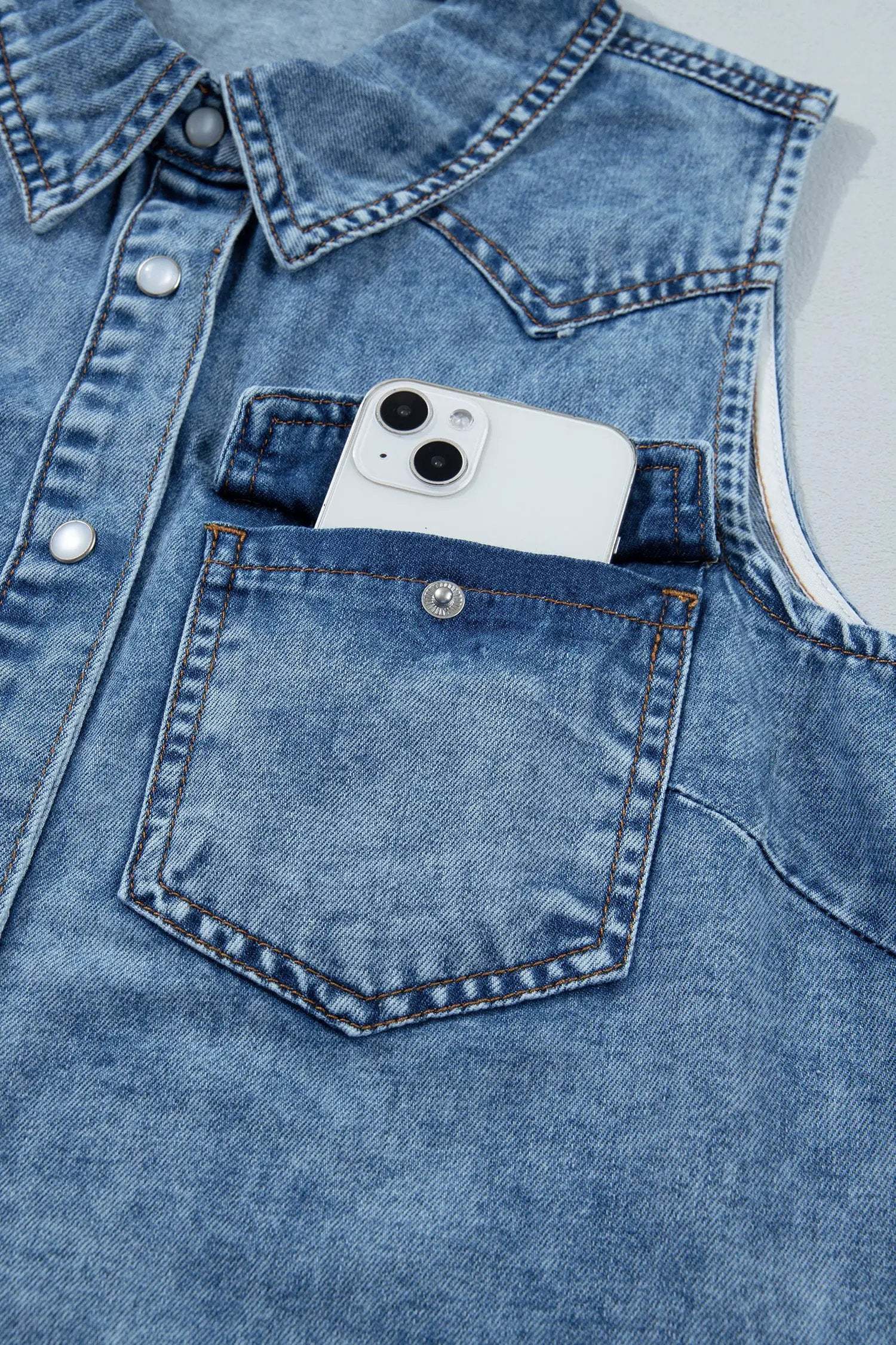 Western Chic sleeveless button-front collared denim top in soft blue with metallic snaps and chest pockets