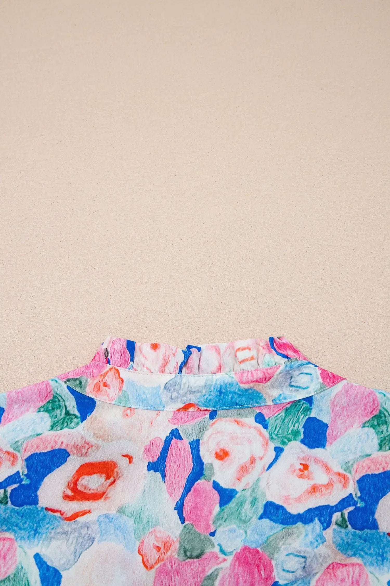 Lightweight floral print tie-neck blouse with V-neck and ruffle short sleeves, perfect for vacation vibe.