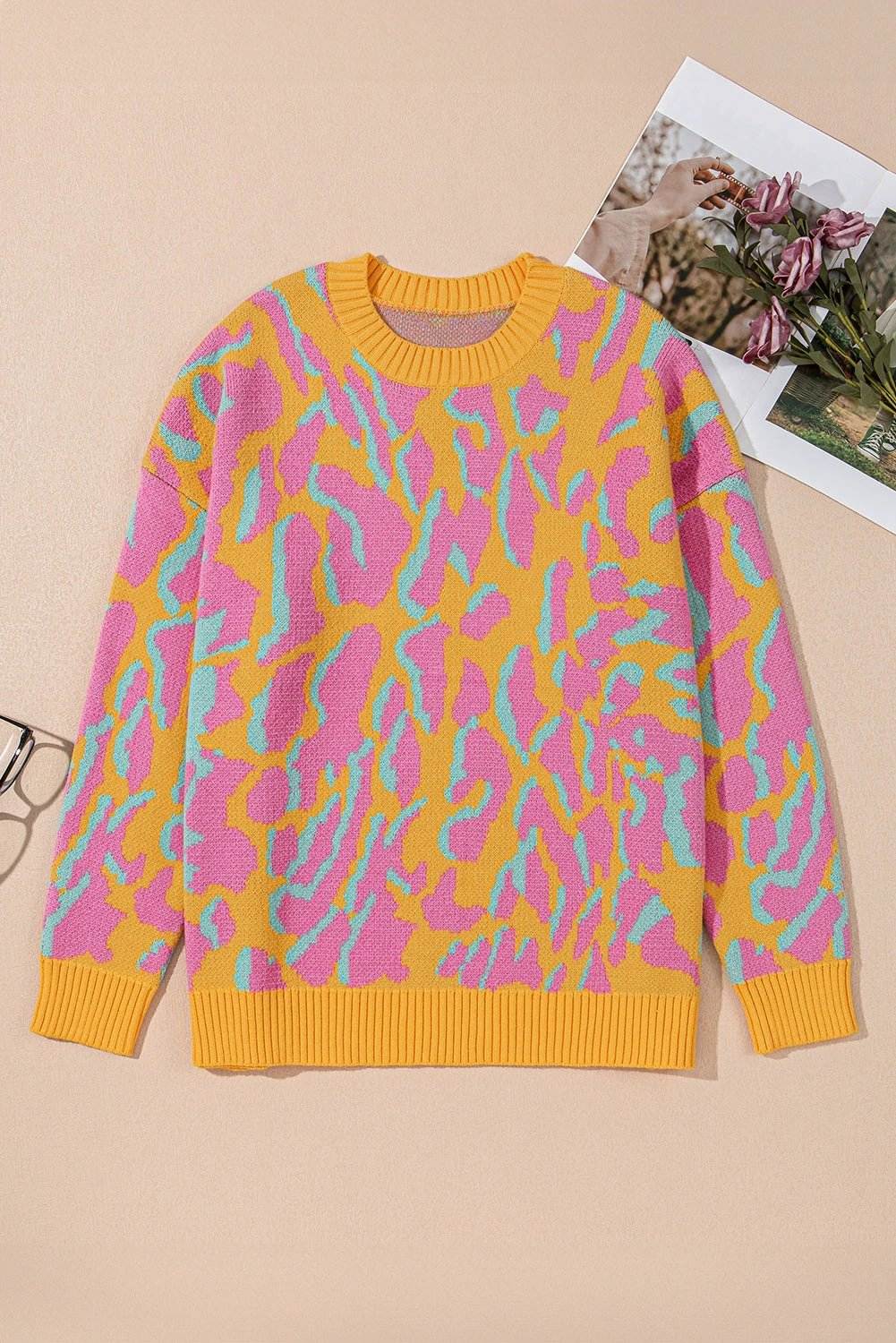 Plus size leopard print sweater with ribbed trim and relaxed fit