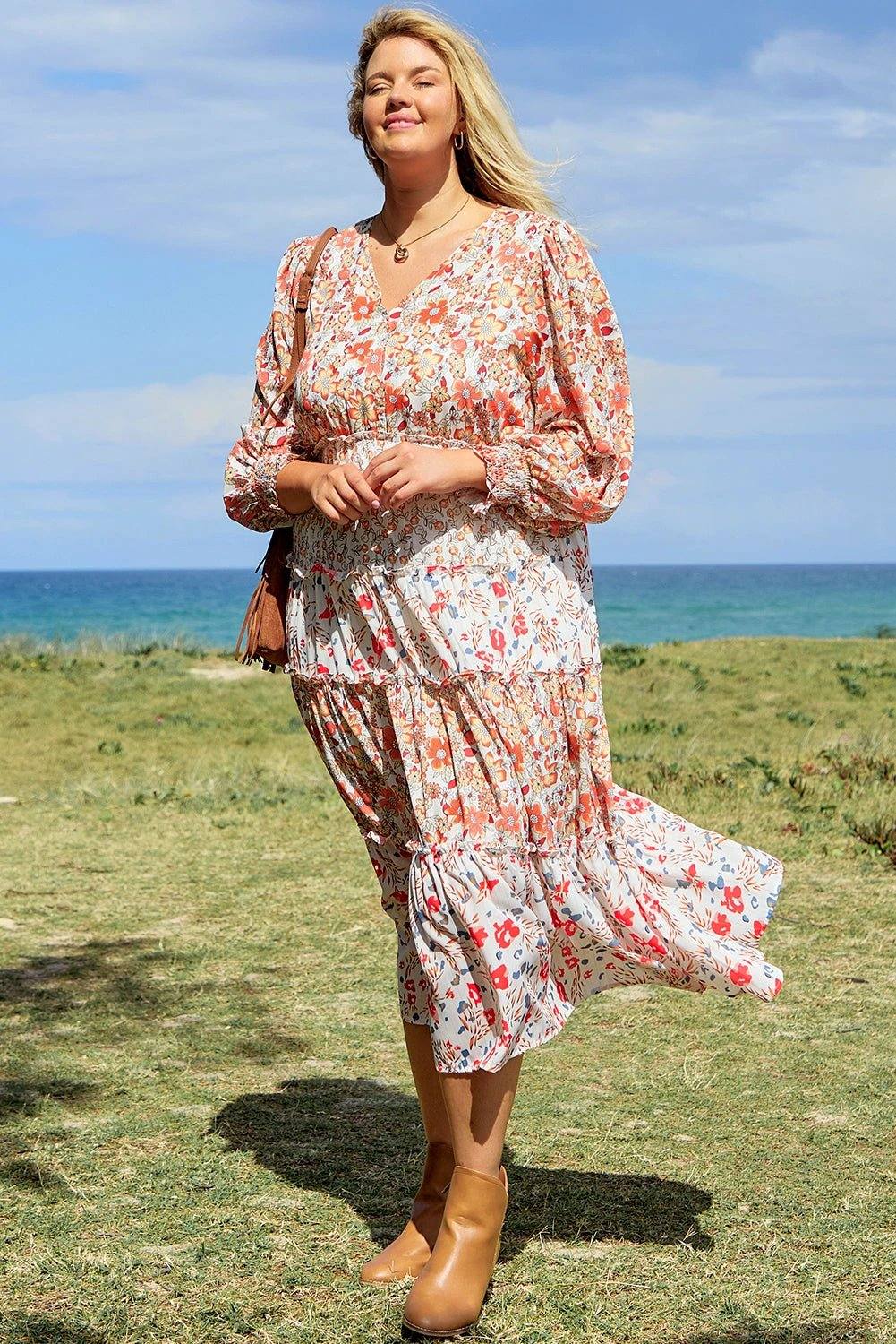 Plus size boho floral tiered ruffle maxi dress with long sleeves and flowing silhouette, embodying main character energy.
