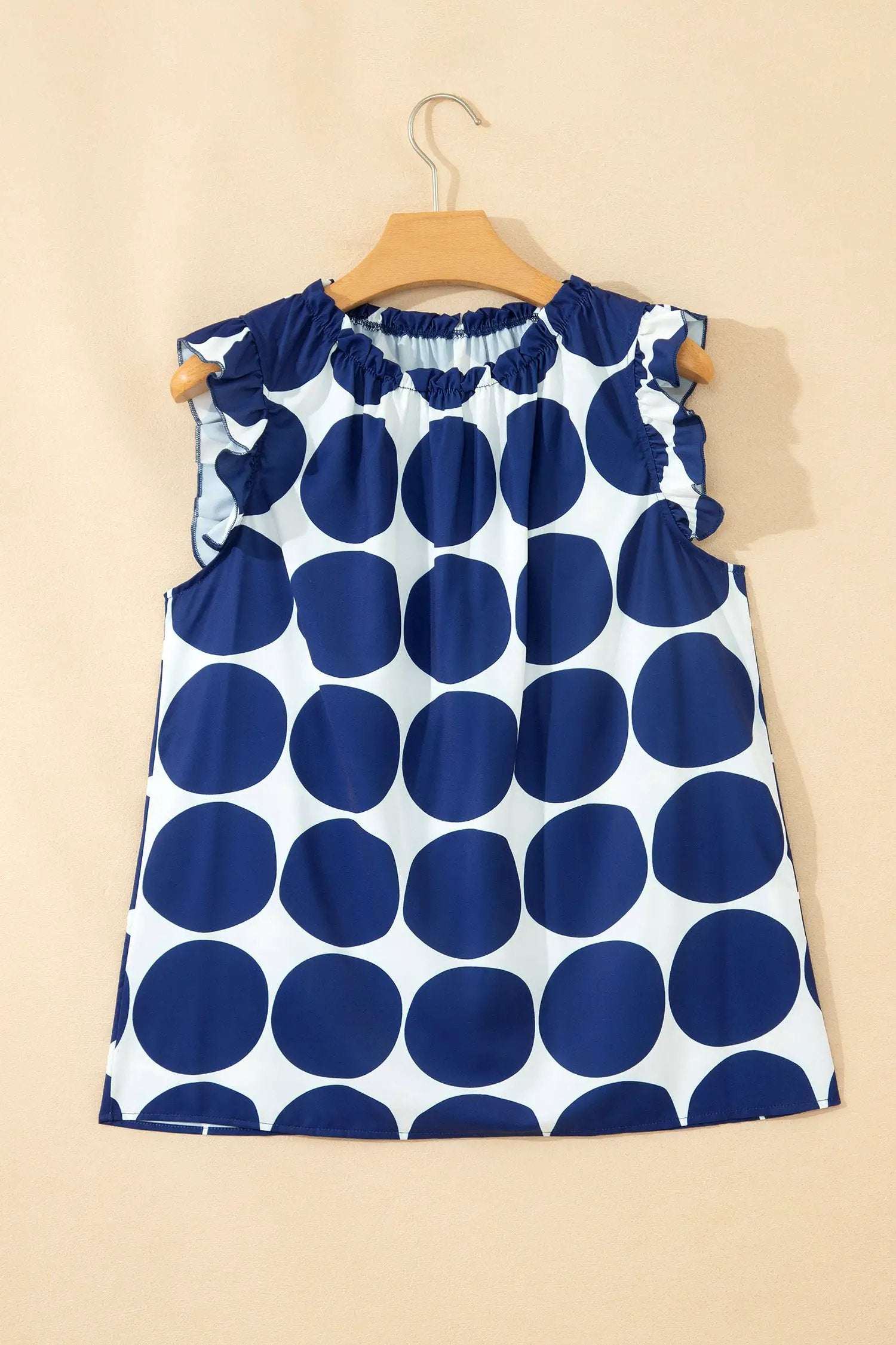 Blue and white polka dot tank top with frilled round neckline and sleeveless design