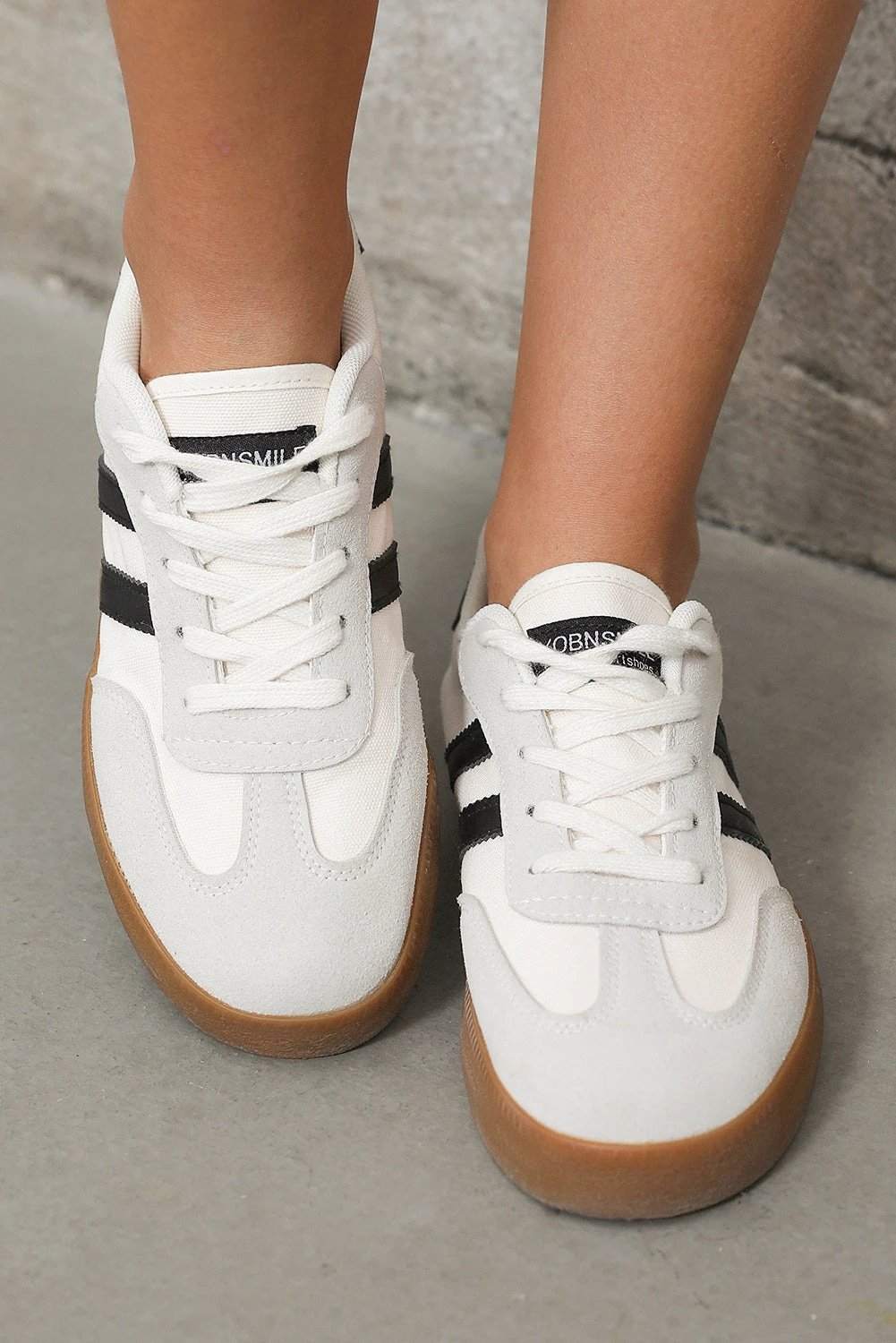 White striped lace-up flat sneakers with gum sole for casual chic mom energy style