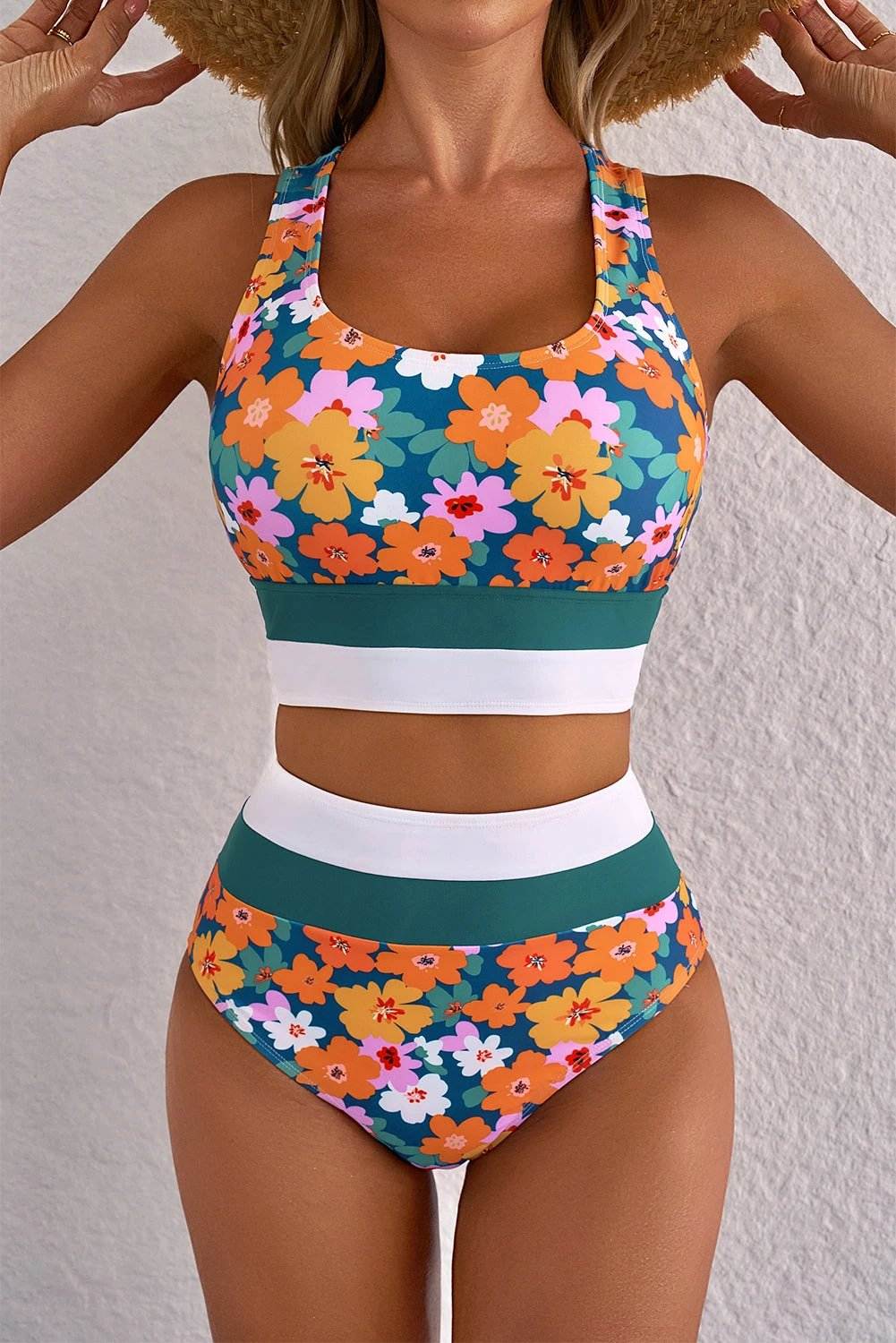 Woman wearing floral print racerback cutout high-waist two-piece bikini on the beach with sun-kissed confidence