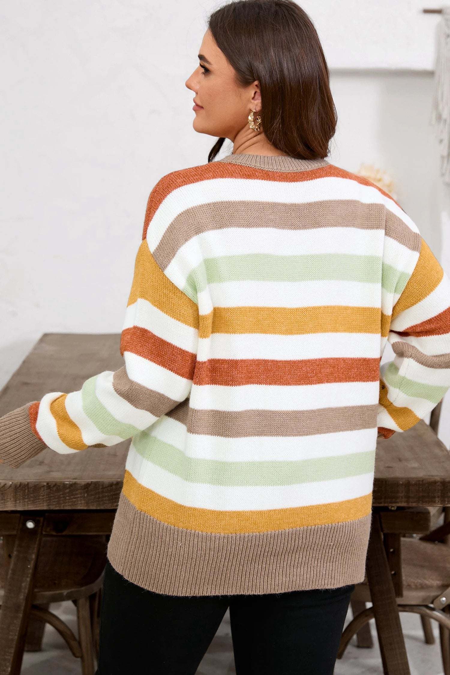 Plus size striped colorblock drop shoulder sweater in earthy tones on model