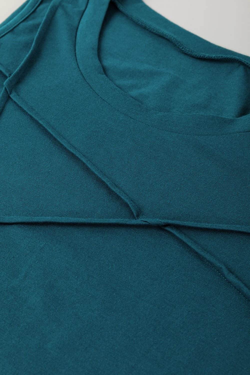 Sapphire-green round neck tank top with diagonal stitching detail and relaxed fit