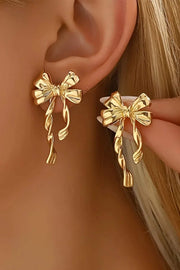 Gold bow knot plated alloy stud earrings with polished finish