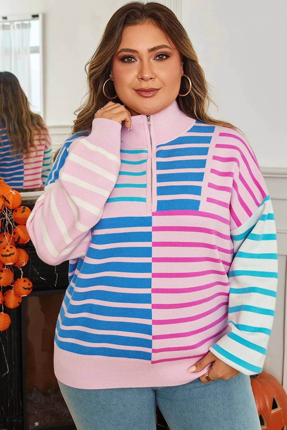 Plus size striped colorblock half zip sweater in pastel pink, blue, and white with relaxed fit and ribbed cuffs