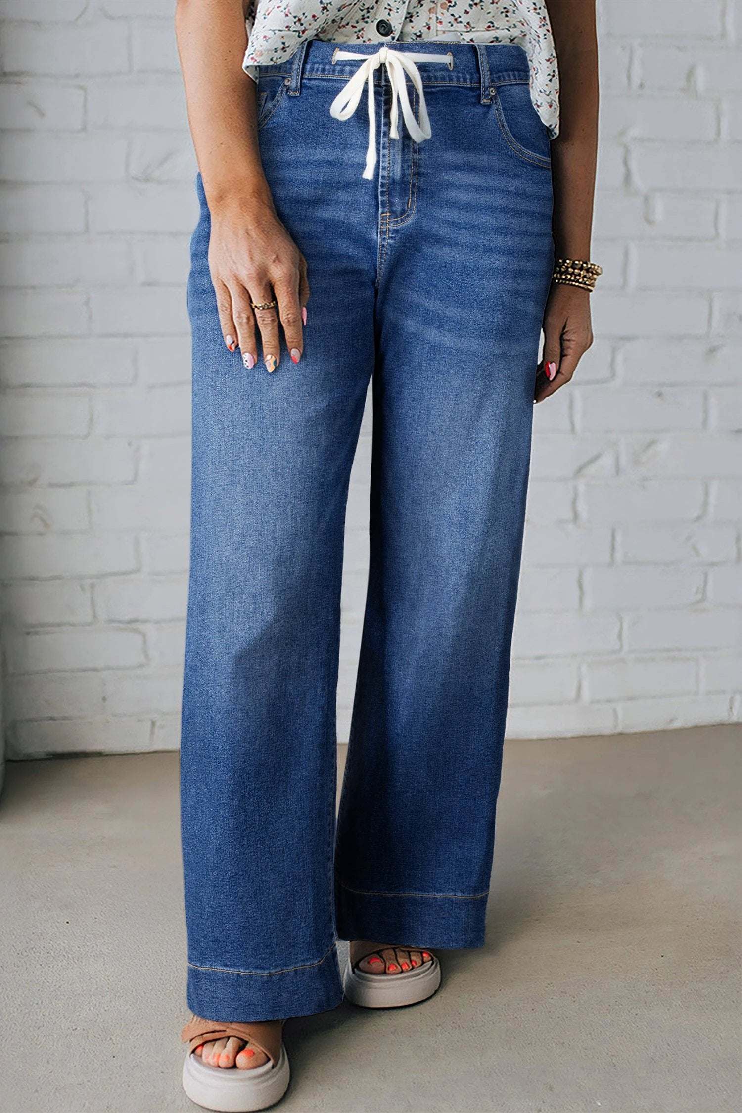 Plus size acid wash lace-up high rise wide leg jeans embodying main character energy.