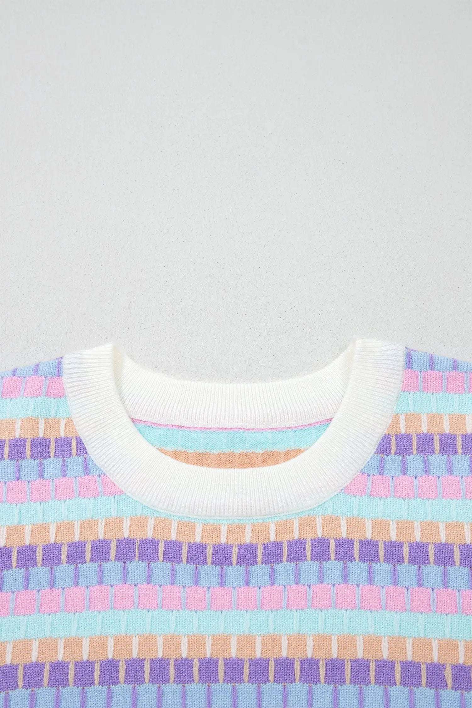 Orange striped knit sweater with short sleeves and abstract orange stripes on vibrant knit fabric