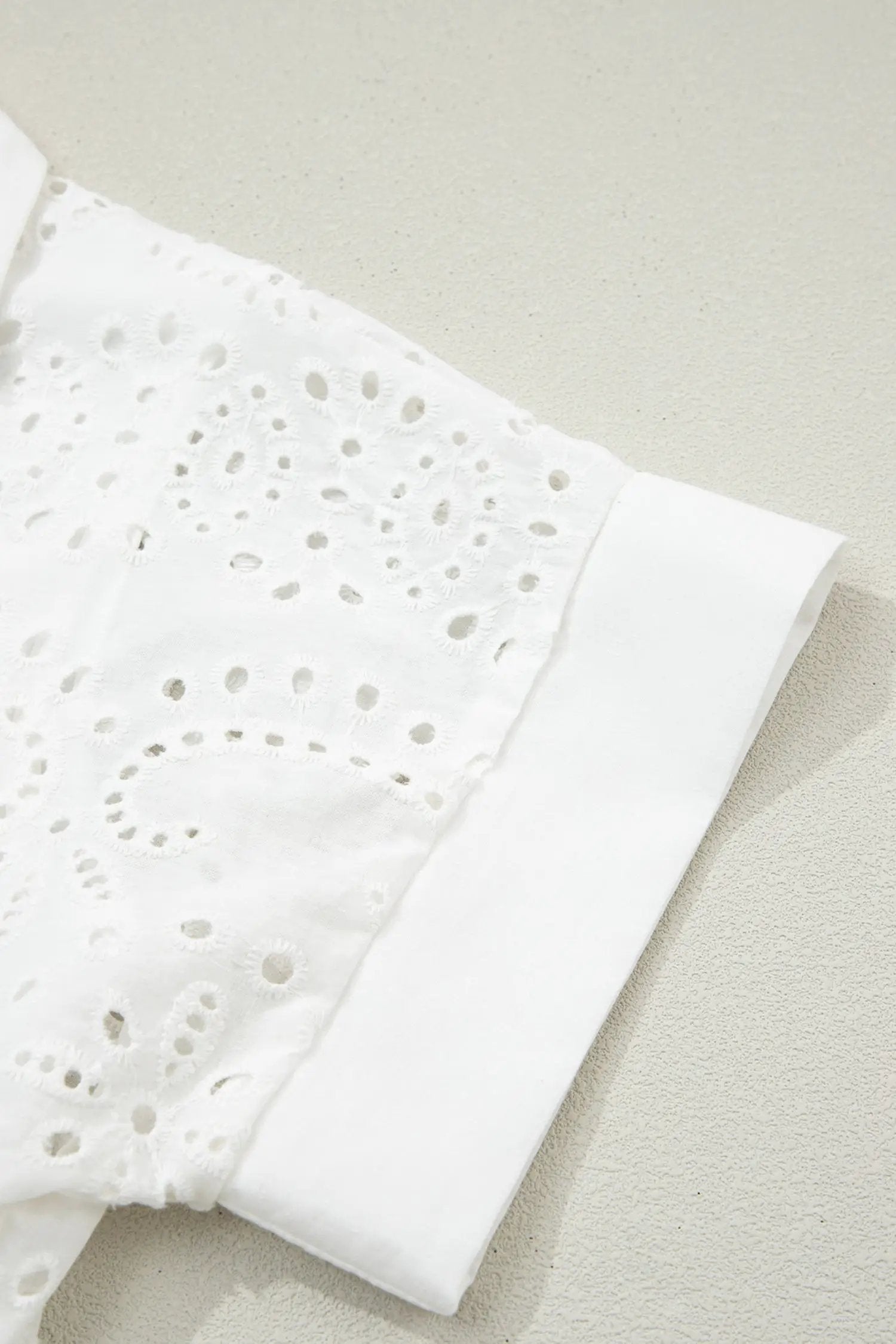 White solid color eyelet embroidered T shirt mini dress with short sleeves and A-line silhouette