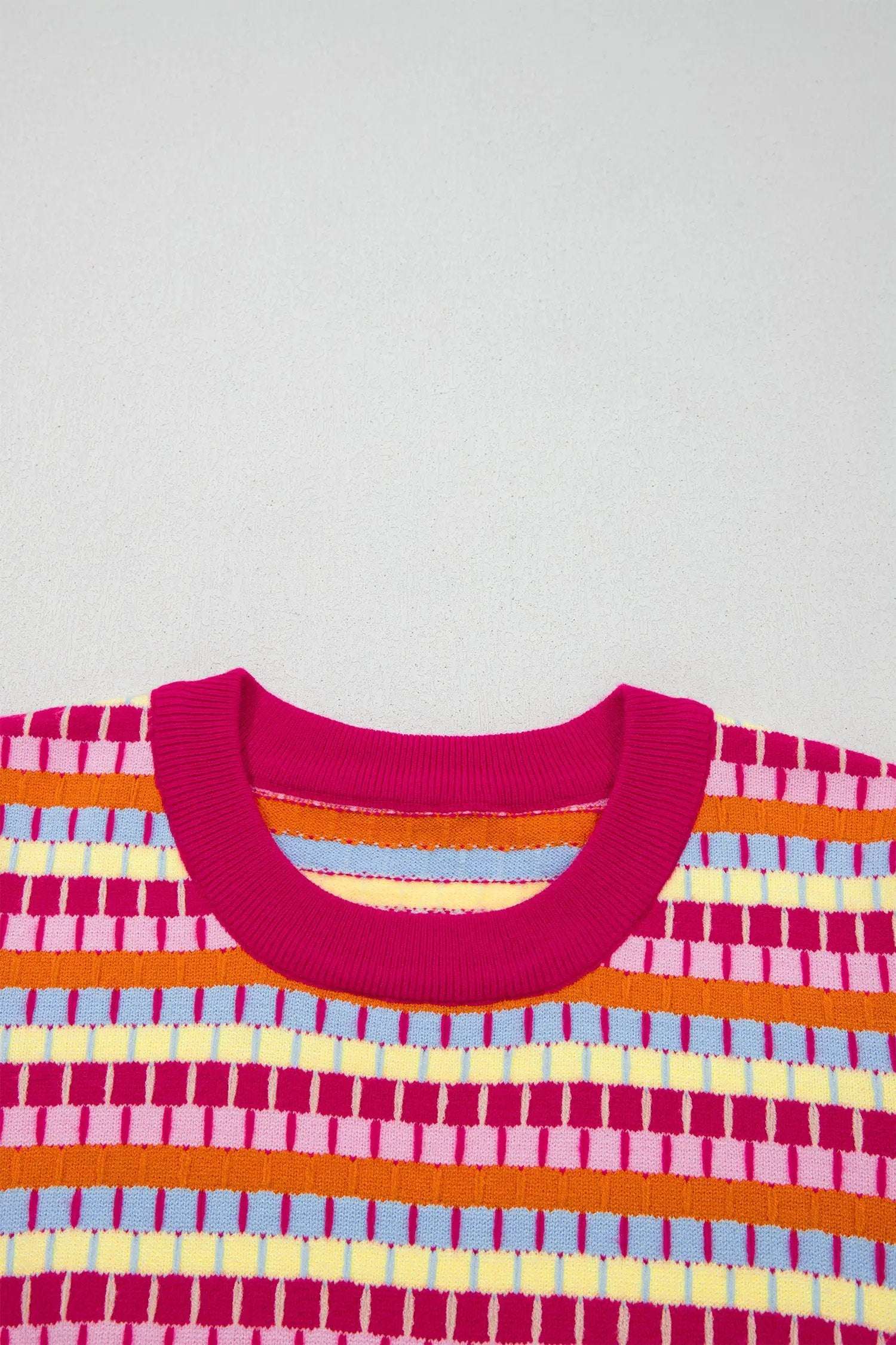 Orange striped knit sweater with abstract bold stripes and short sleeves