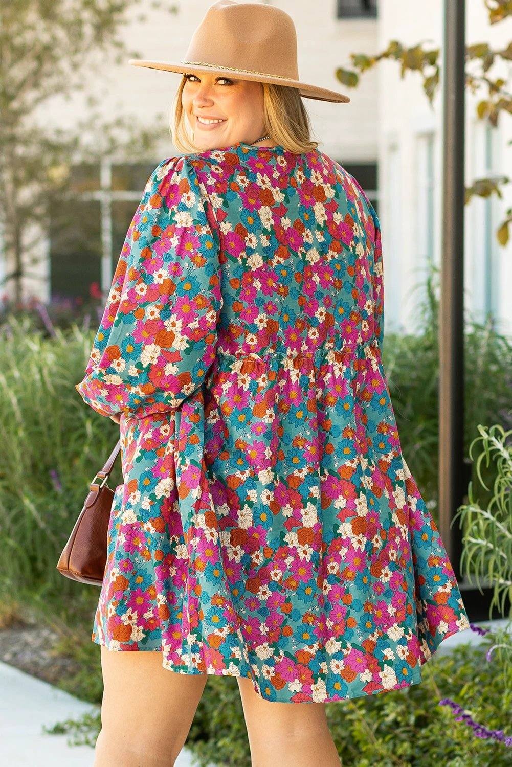 Plus size floral shirred ruffle tiered mini dress on mannequin with lightweight fabric and flattering silhouette