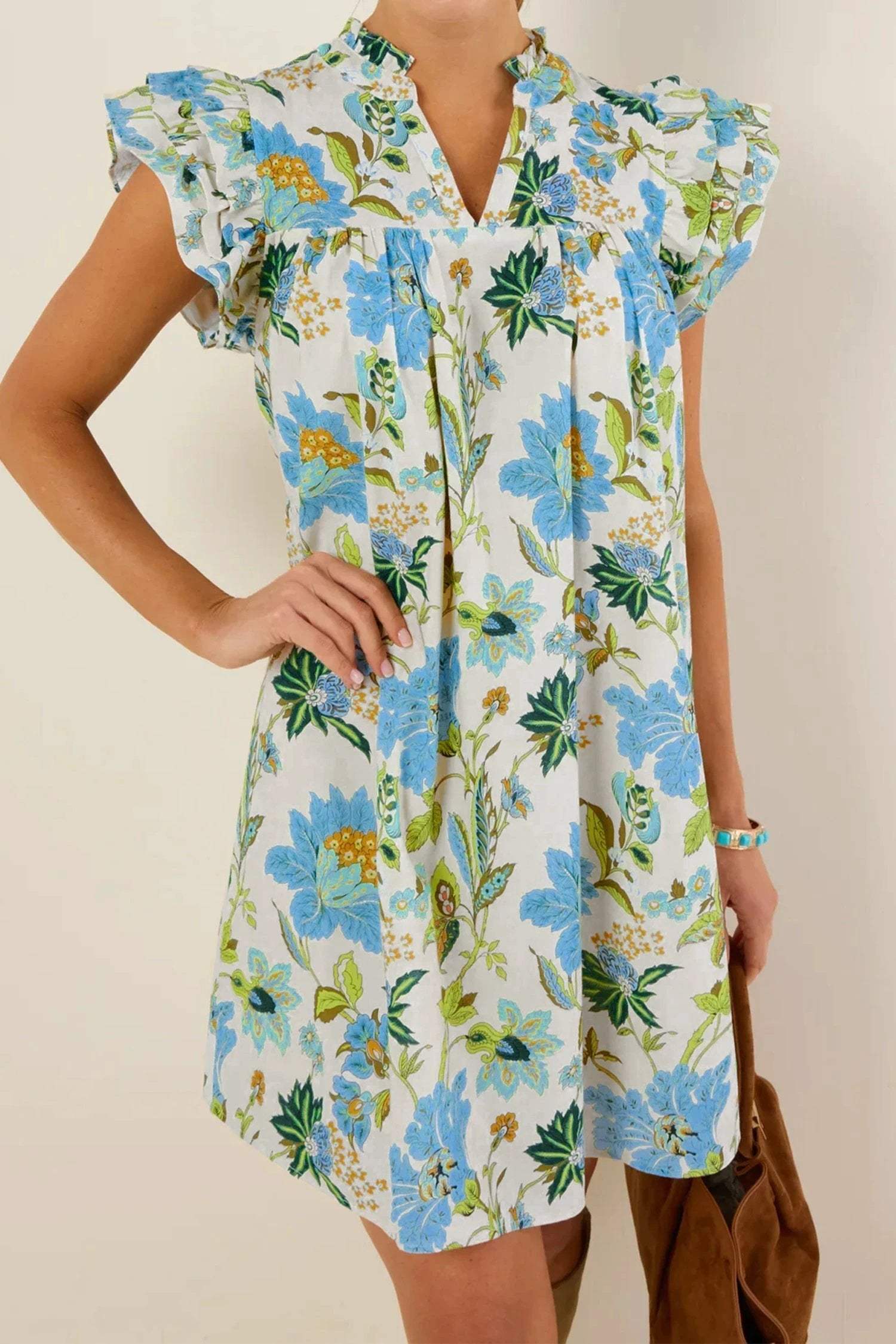 Woman wearing Main Character Energy floral print V-neck mini dress with triple ruffle short sleeves.
