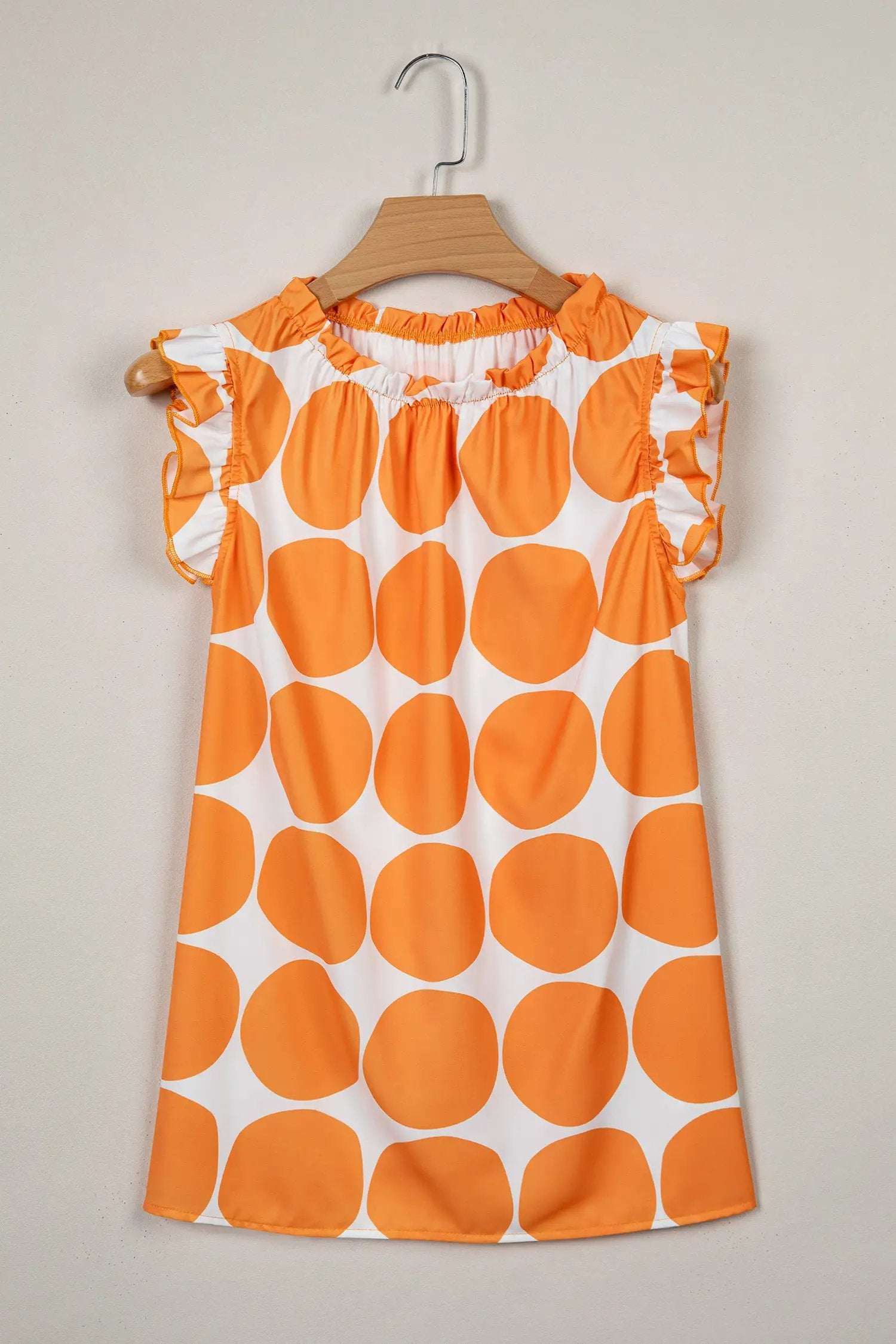 Blue and white polka dot tank top with frilled round neckline and sleeveless design