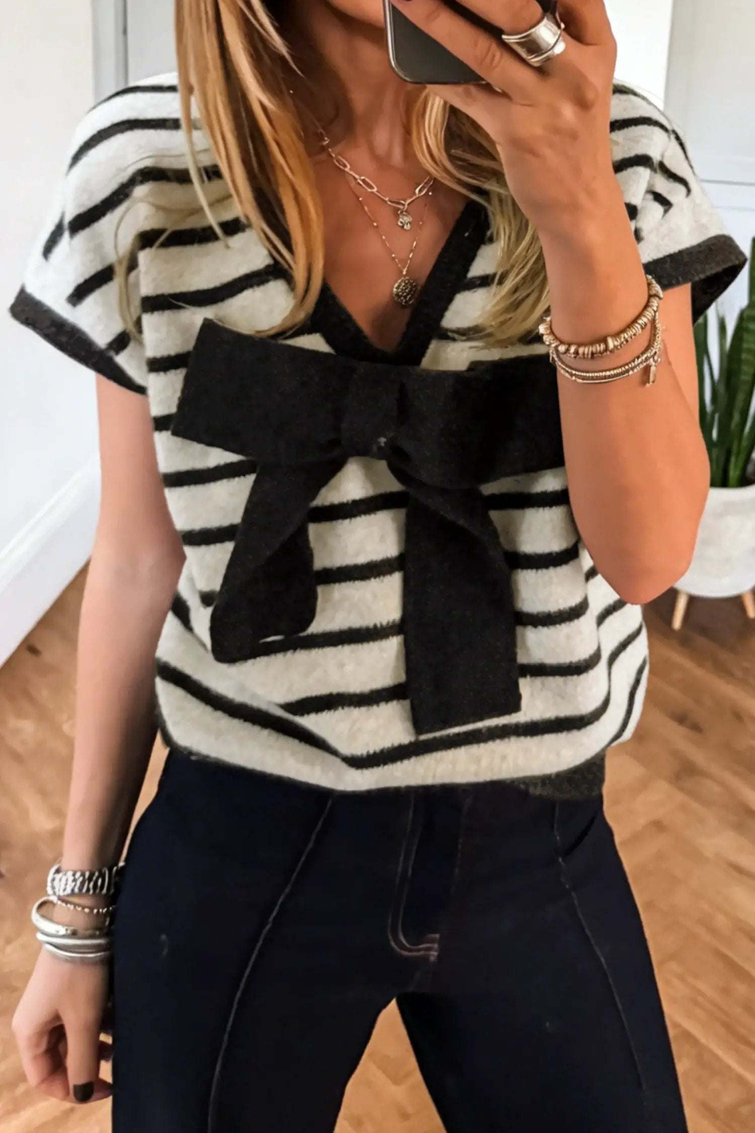 Black stripe knit short sleeve top with front bow detail and relaxed fit