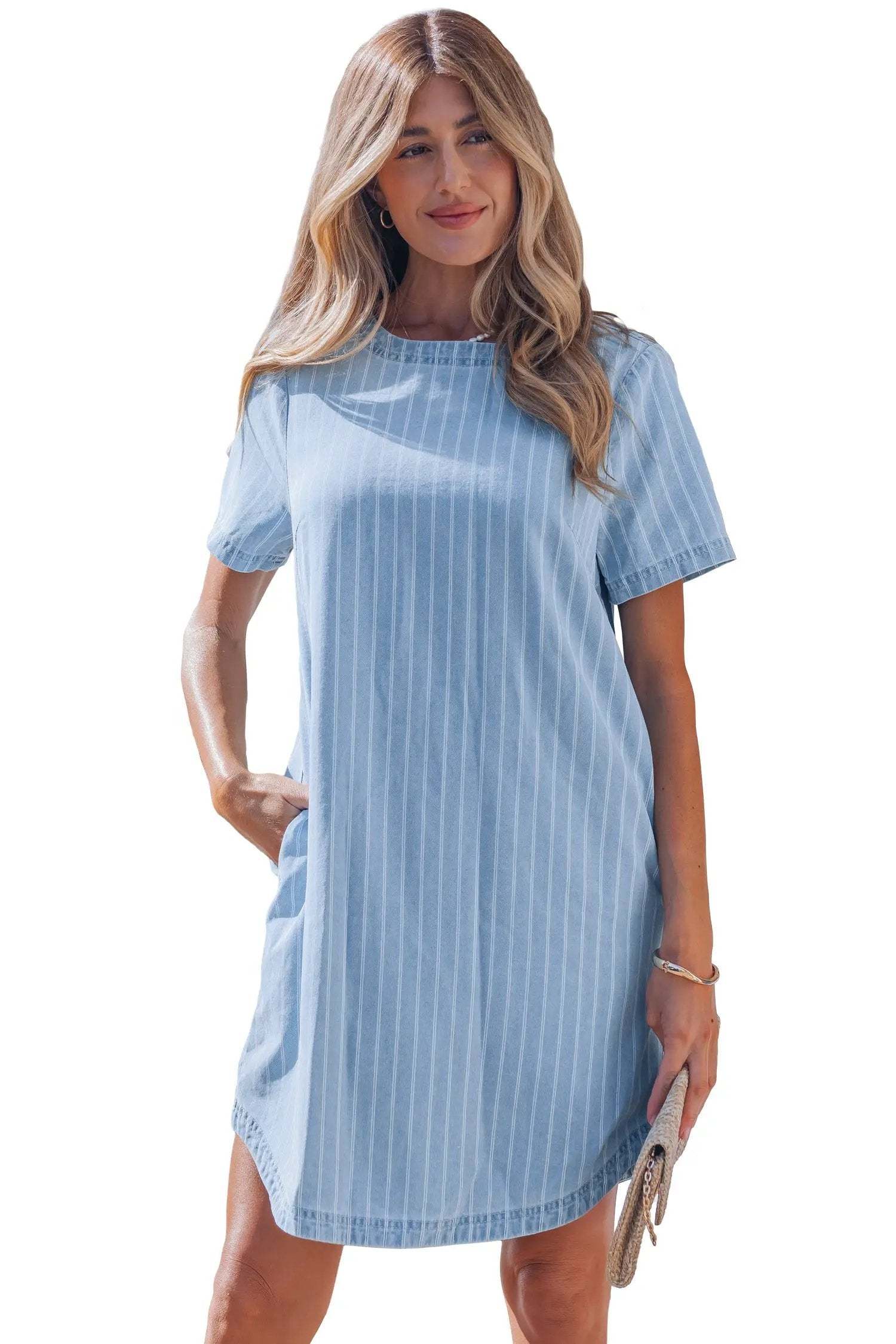 Woman wearing stripe denim mini dress with buttoned back and vertical stripes