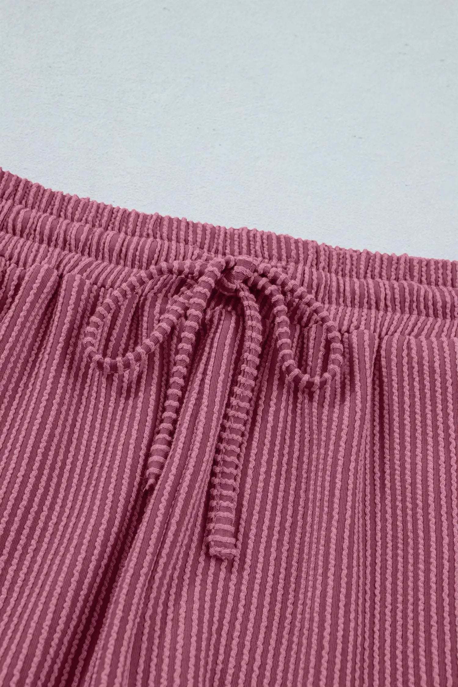 Soft pink twisted ribbed two-piece set with loose tee and shorts for casual mom style