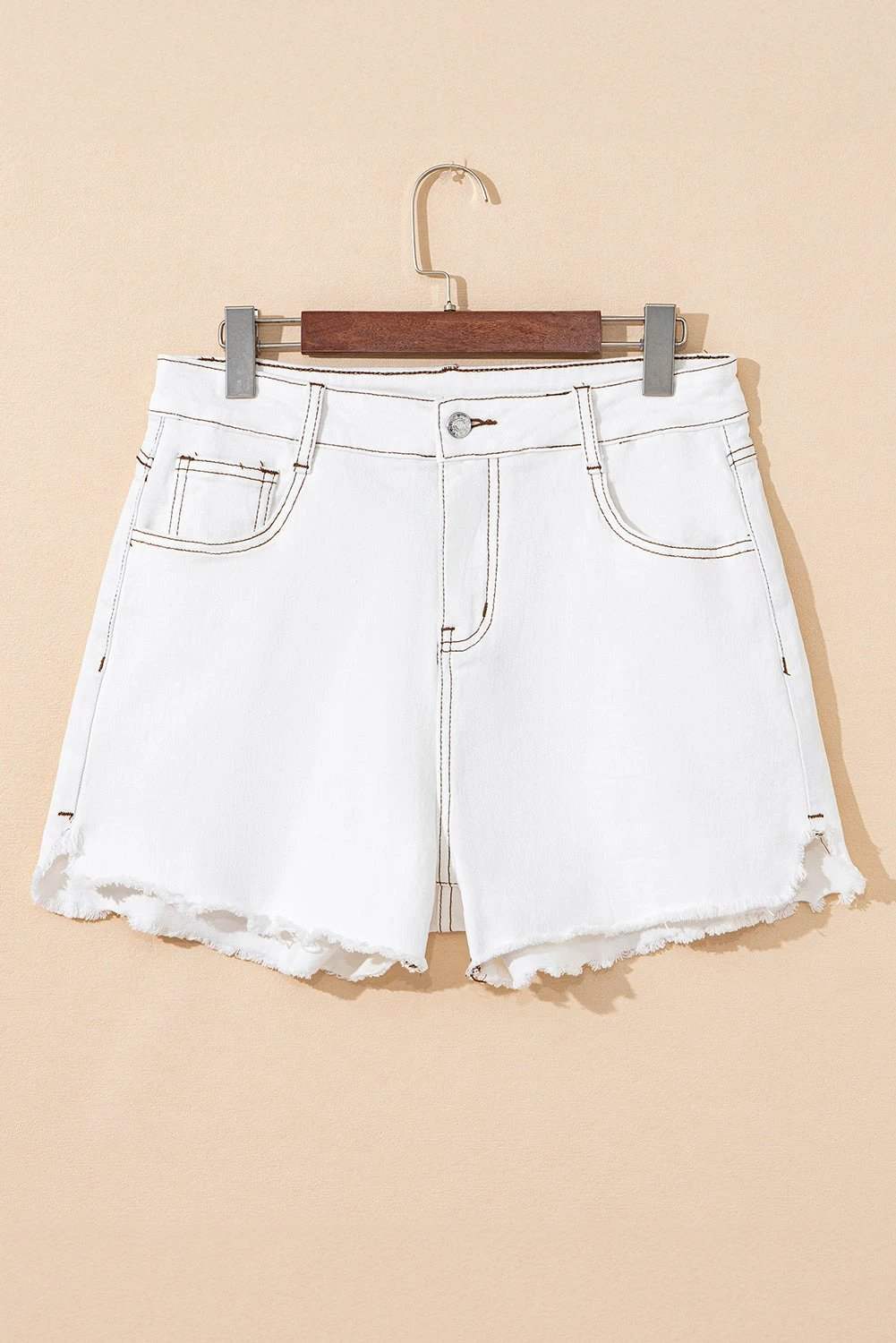 High waist denim shorts with raw hem styled casually for summer wear