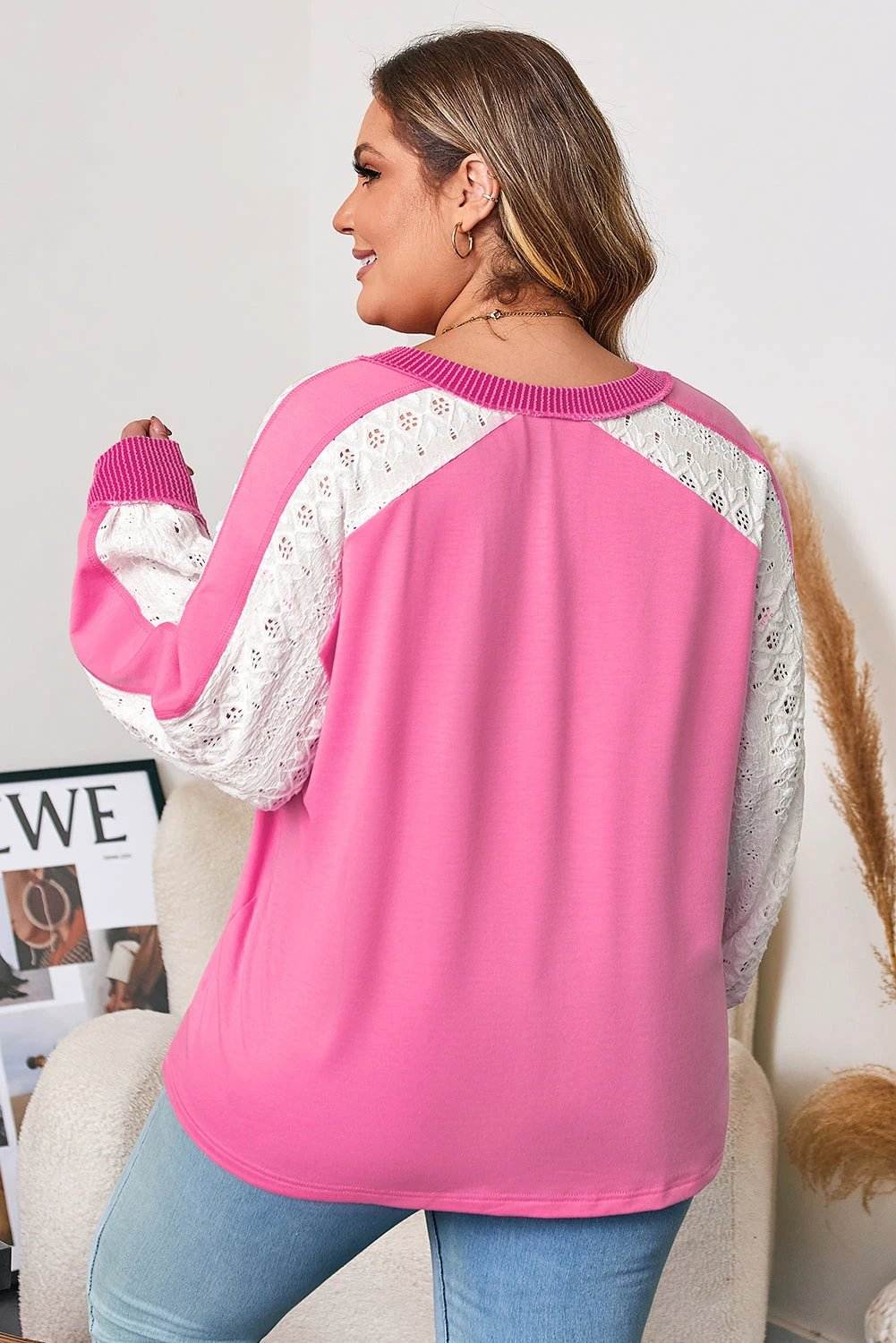 Plus size V-neck top with lace stripe sleeves and corded detail on a plus size model