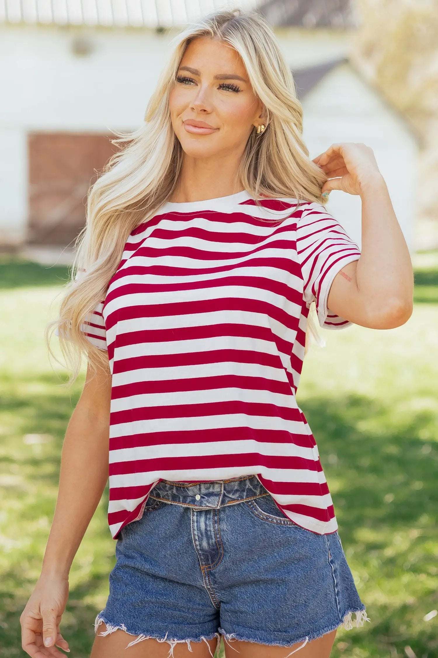Woman wearing a comfortable colorblock stripe tee with a round neck and short sleeves