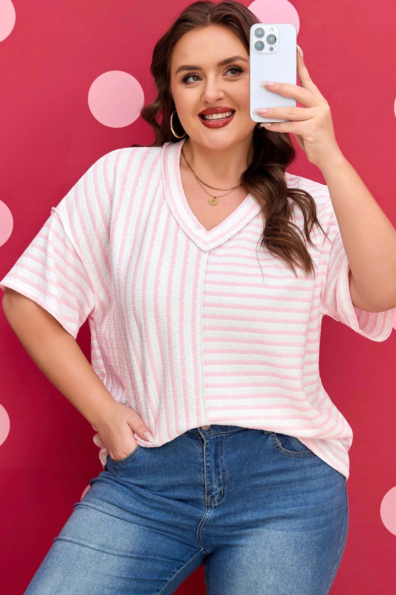 Plus size pink stripe V-neck tee with exposed seam detailing and relaxed fit