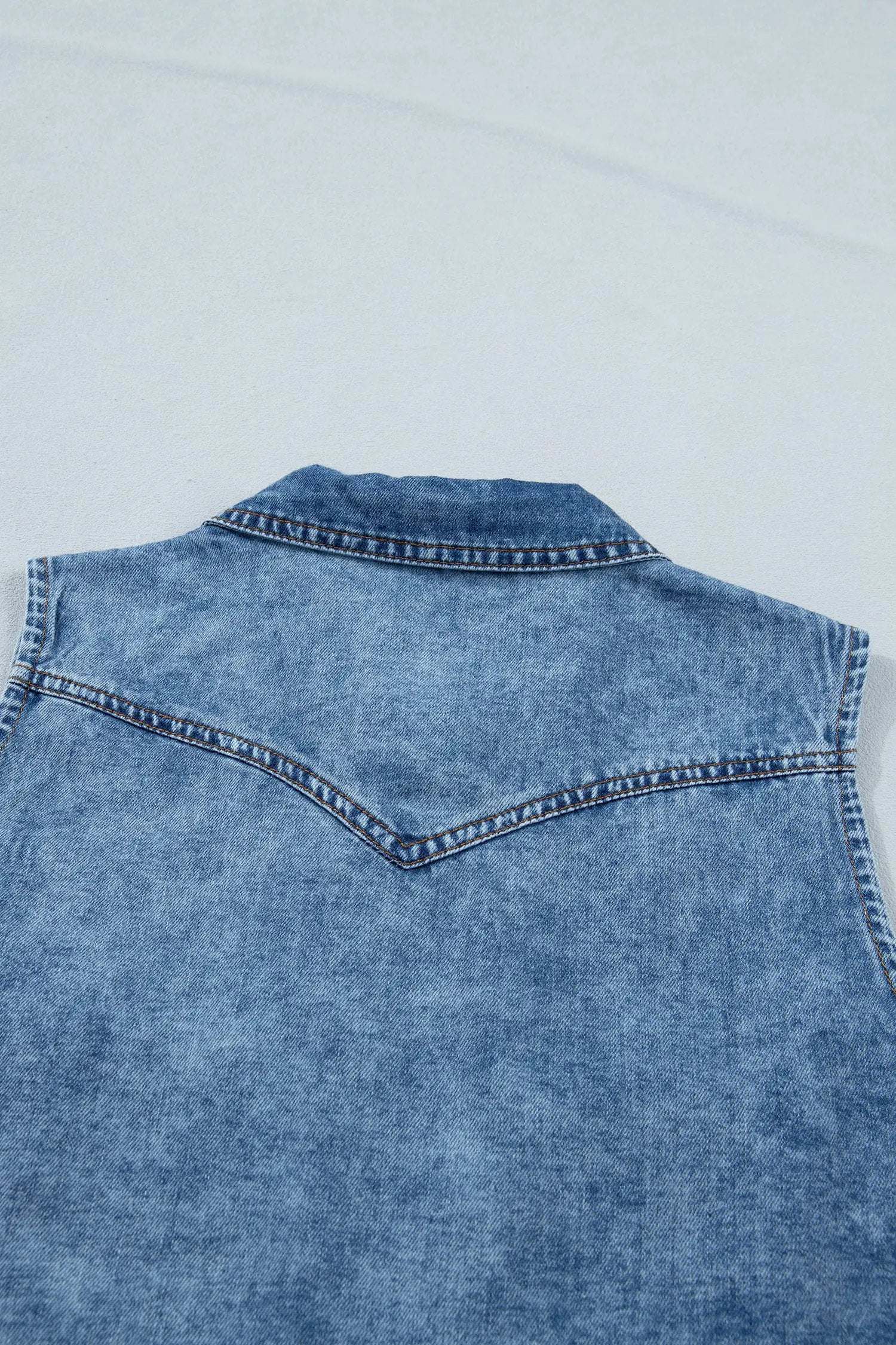 Sleeveless buttoned front collared denim top in soft blue Western chic style