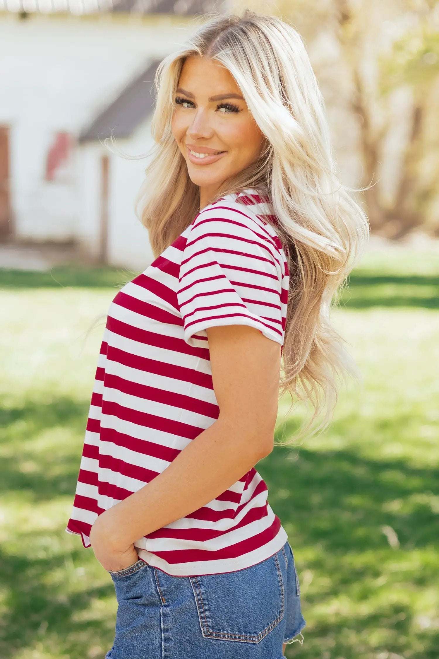 Woman wearing a soft colorblock stripe tee with round neck and short sleeves, styled casually for everyday comfort