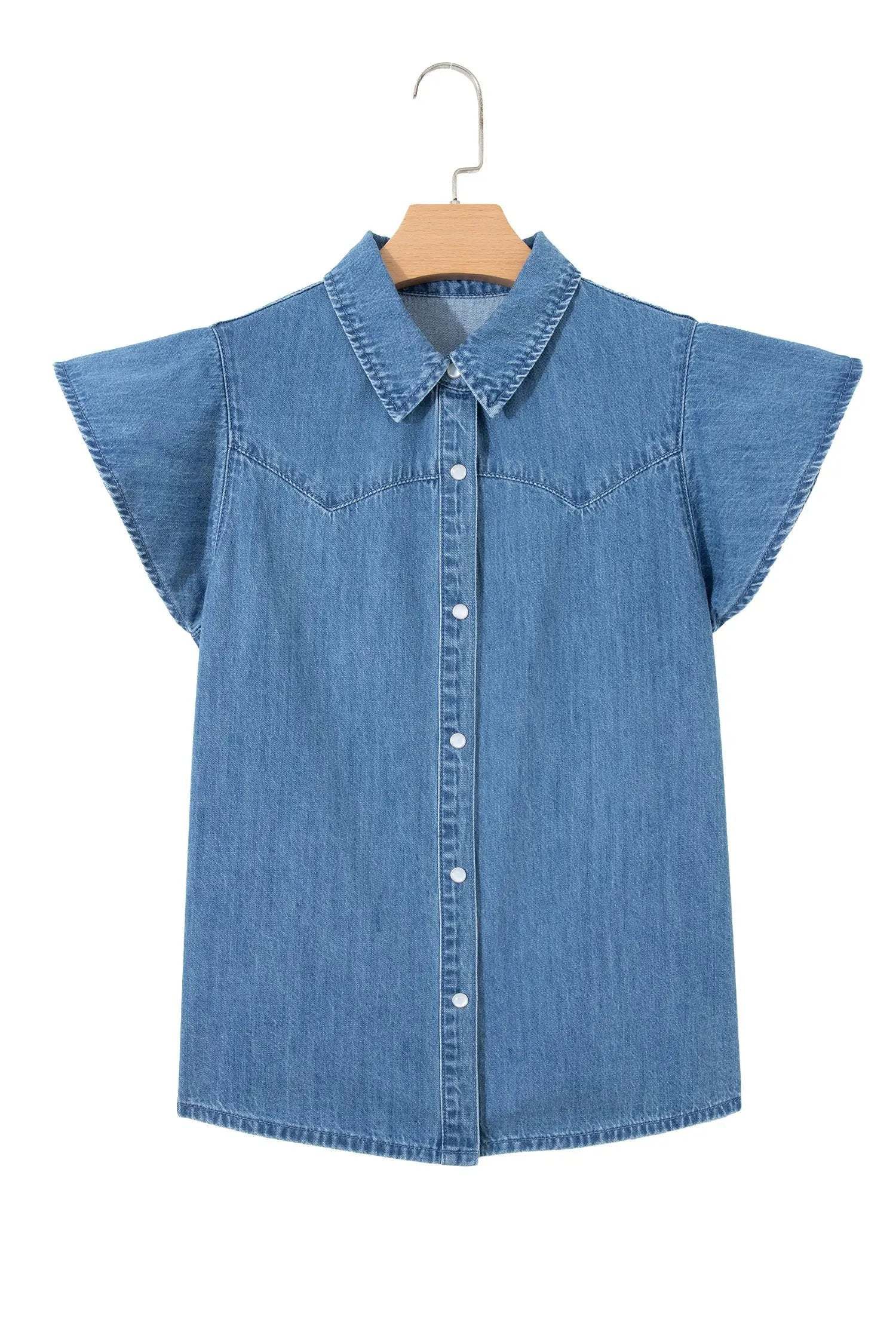 Woman wearing denim ruffled short sleeve shirt with button front and flutter sleeves
