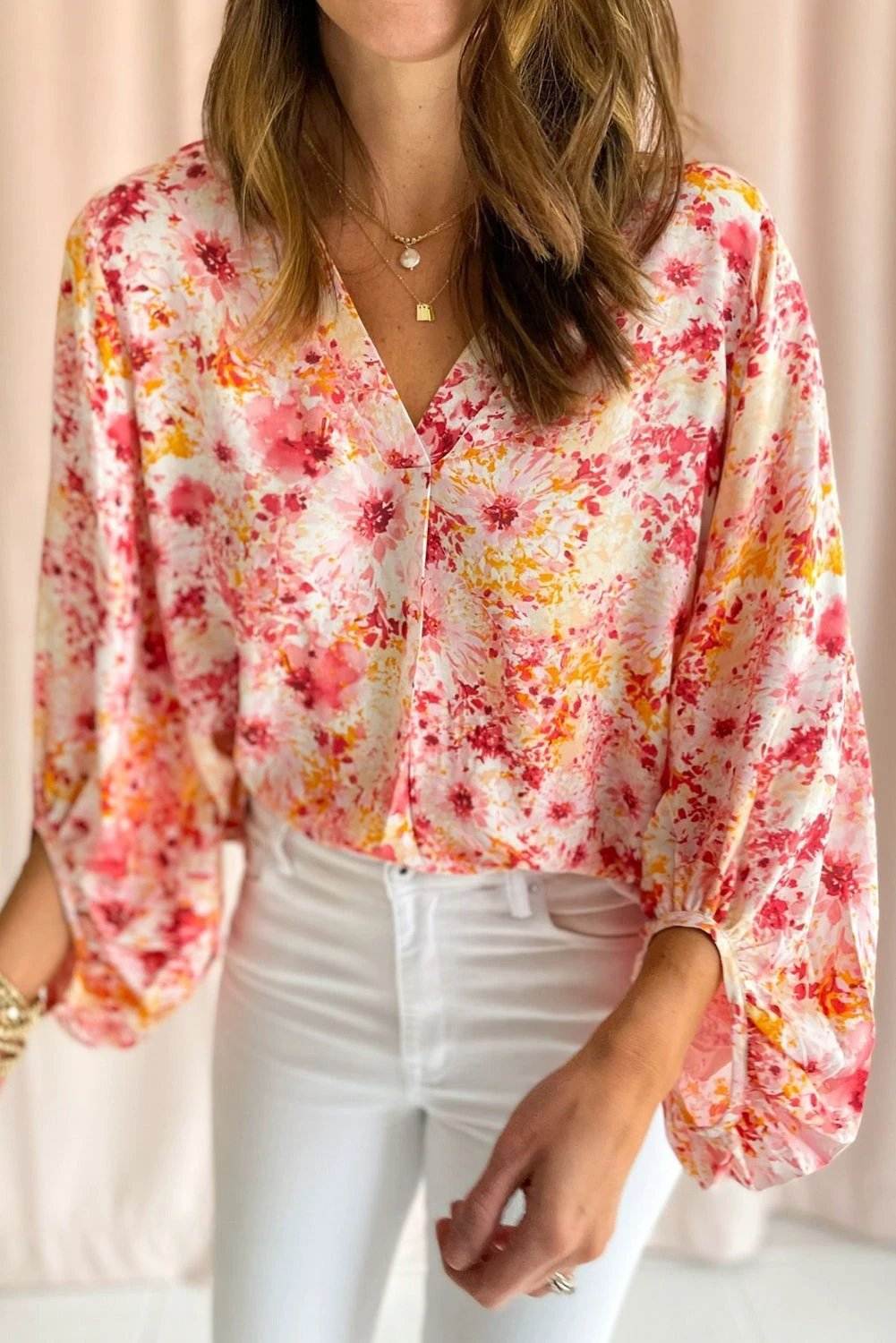 Pink ditsy floral V-neck blouse with bubble sleeves and relaxed fit