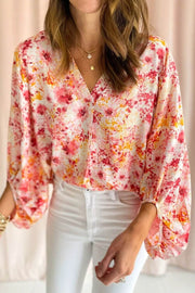 Pink ditsy floral V-neck blouse with bubble sleeves and relaxed fit
