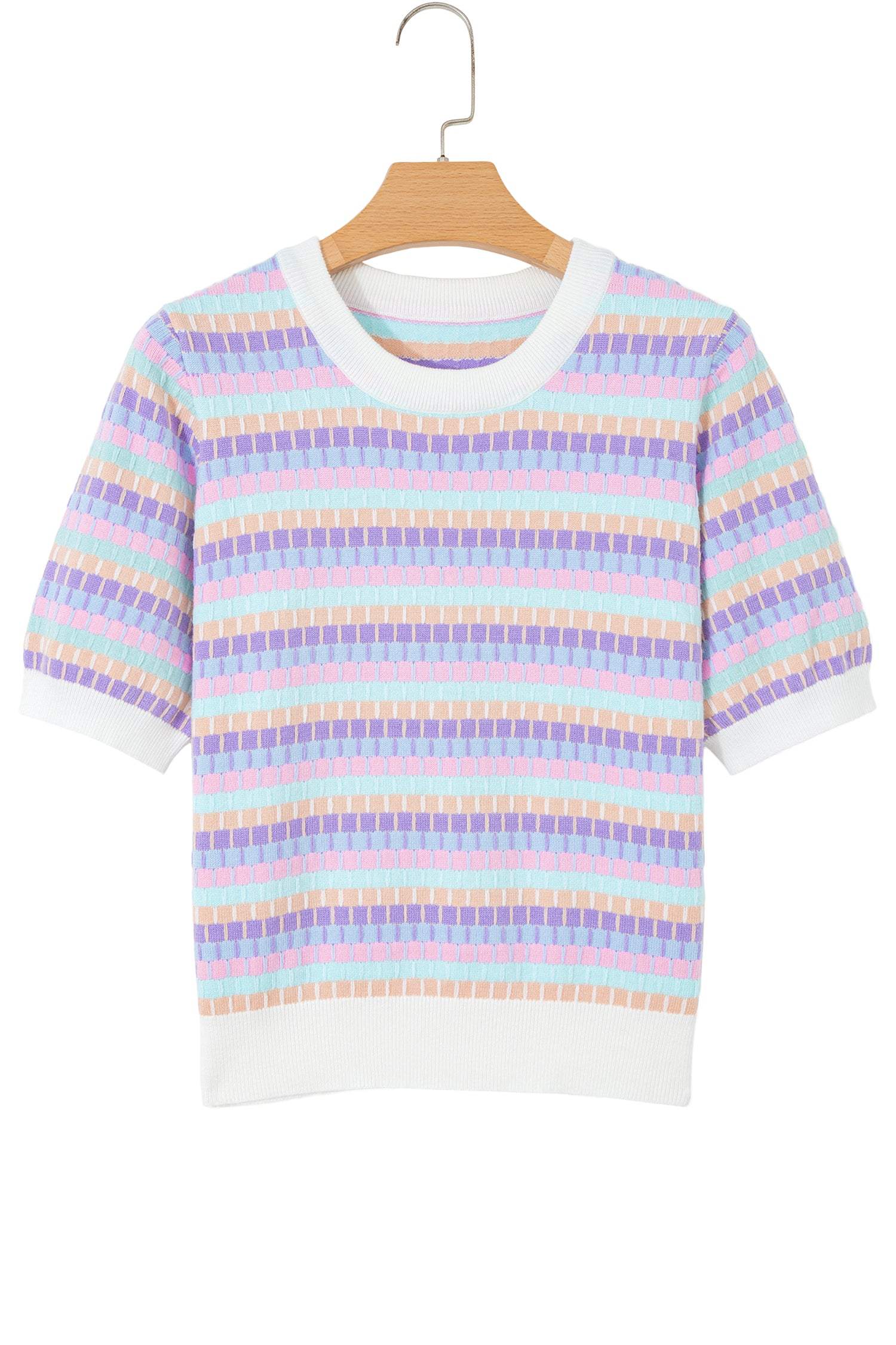 Woman wearing orange striped knit sweater with abstract orange stripes and fuchsia pink rib neckline and cuffs