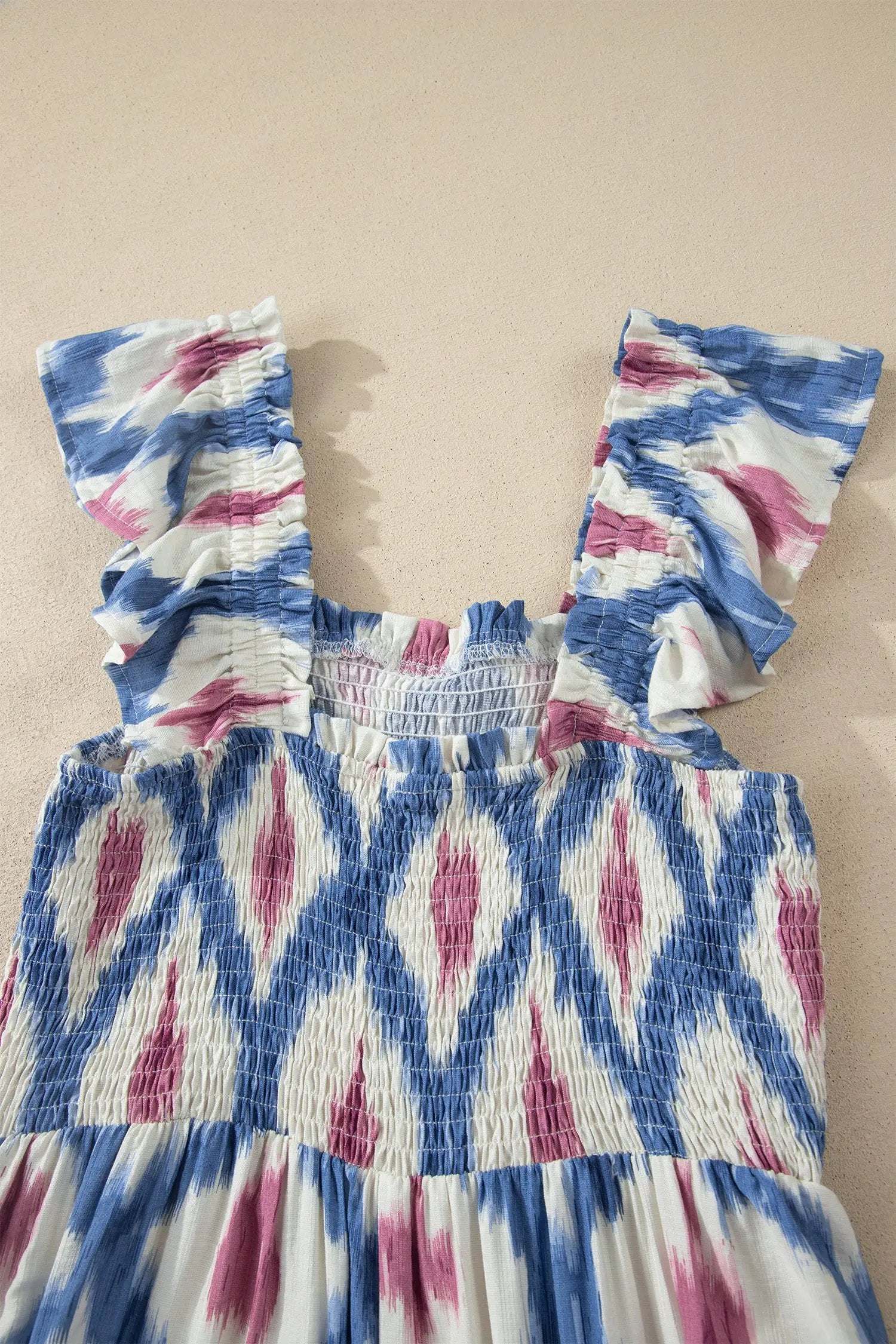 Woman wearing boho vacation vibes geometric print square neck smocked waist ruffle sleeve dress